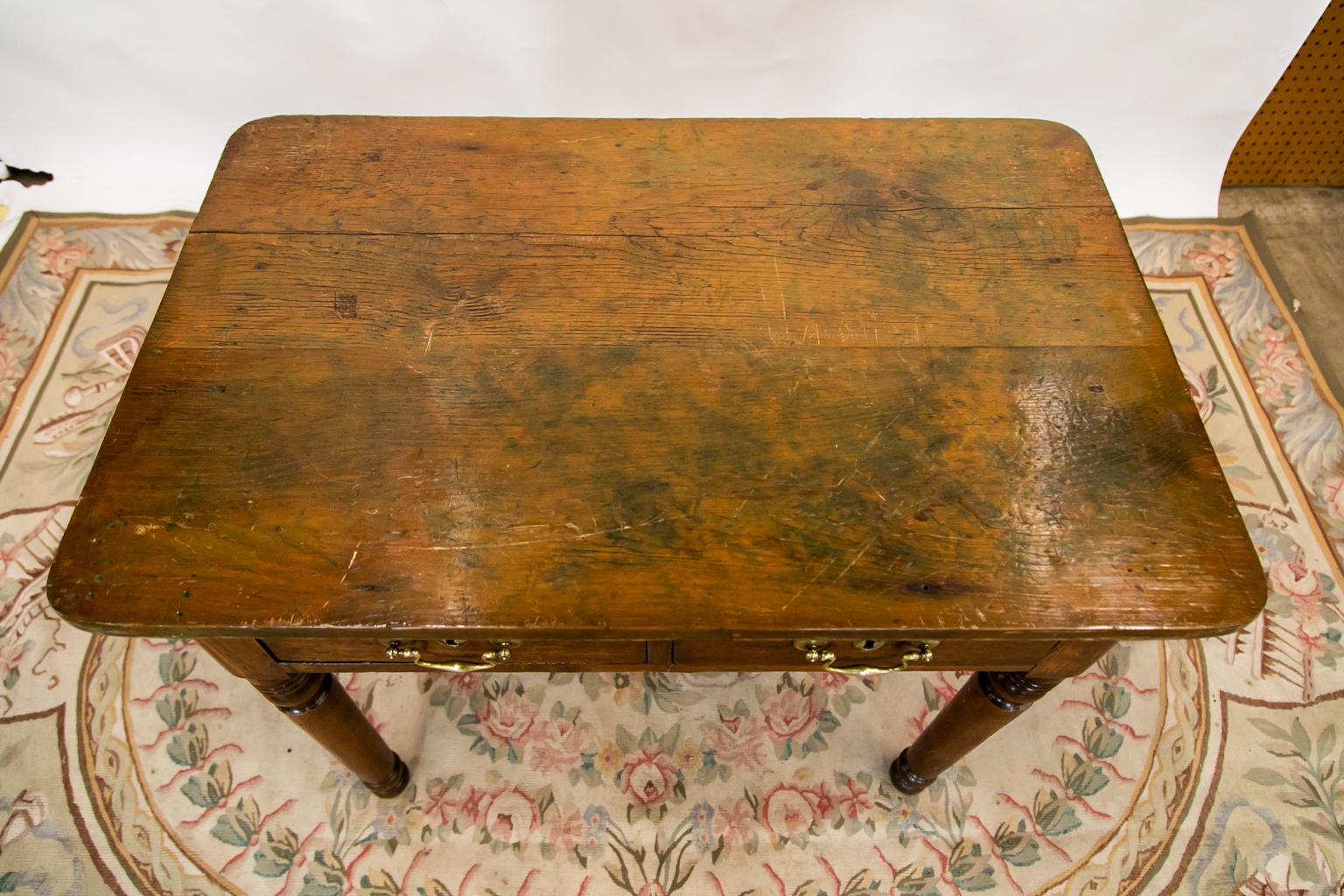 This English side table has shrinkage cracks and some staining to the top patina.