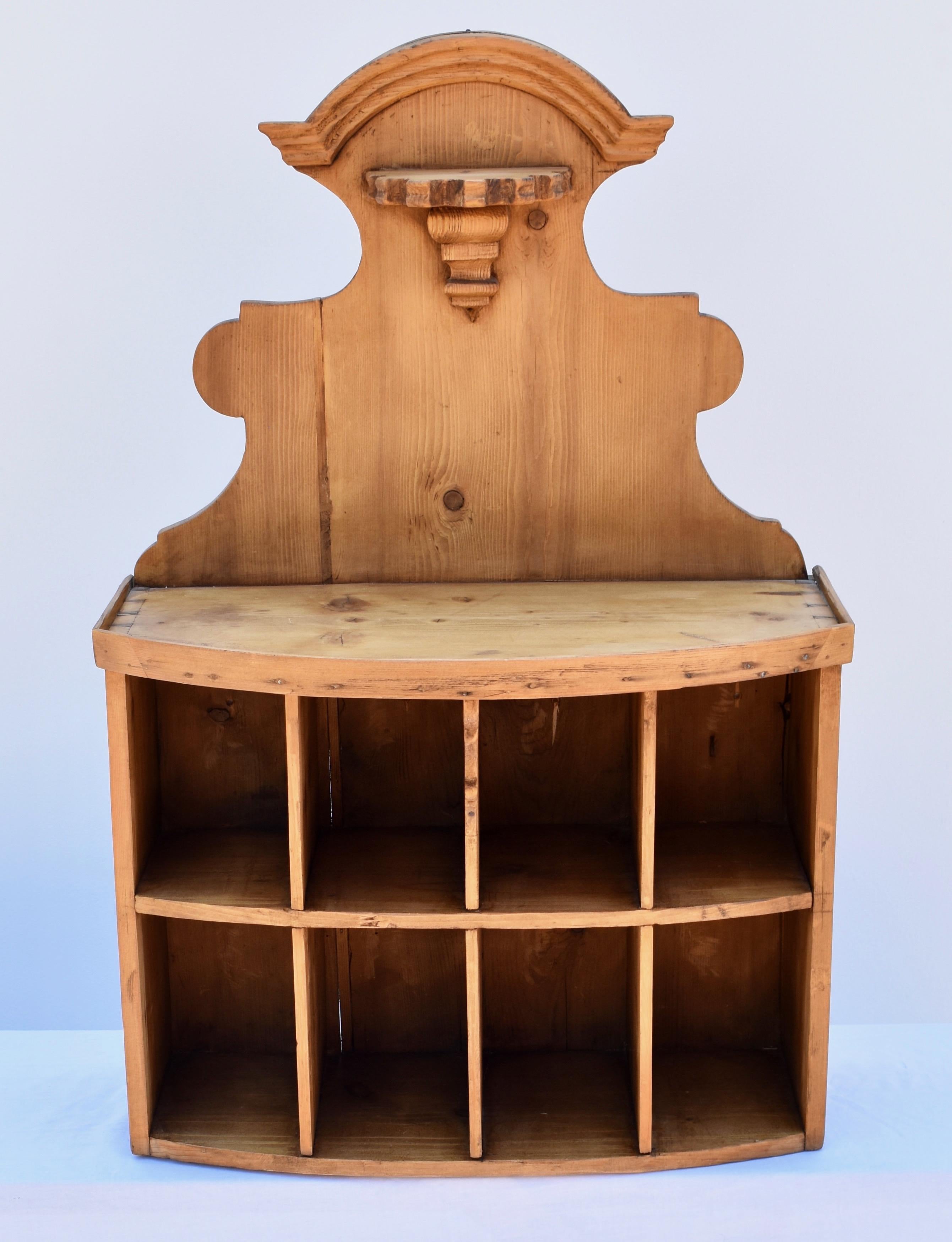 This charming bow-fronted wall rack was probably originally used in a small inn or guest house, its eight 5”x7” cubbies perfect for keys and mail and messages for various guests. This dealer has had it on his office wall for 15 years, where it has