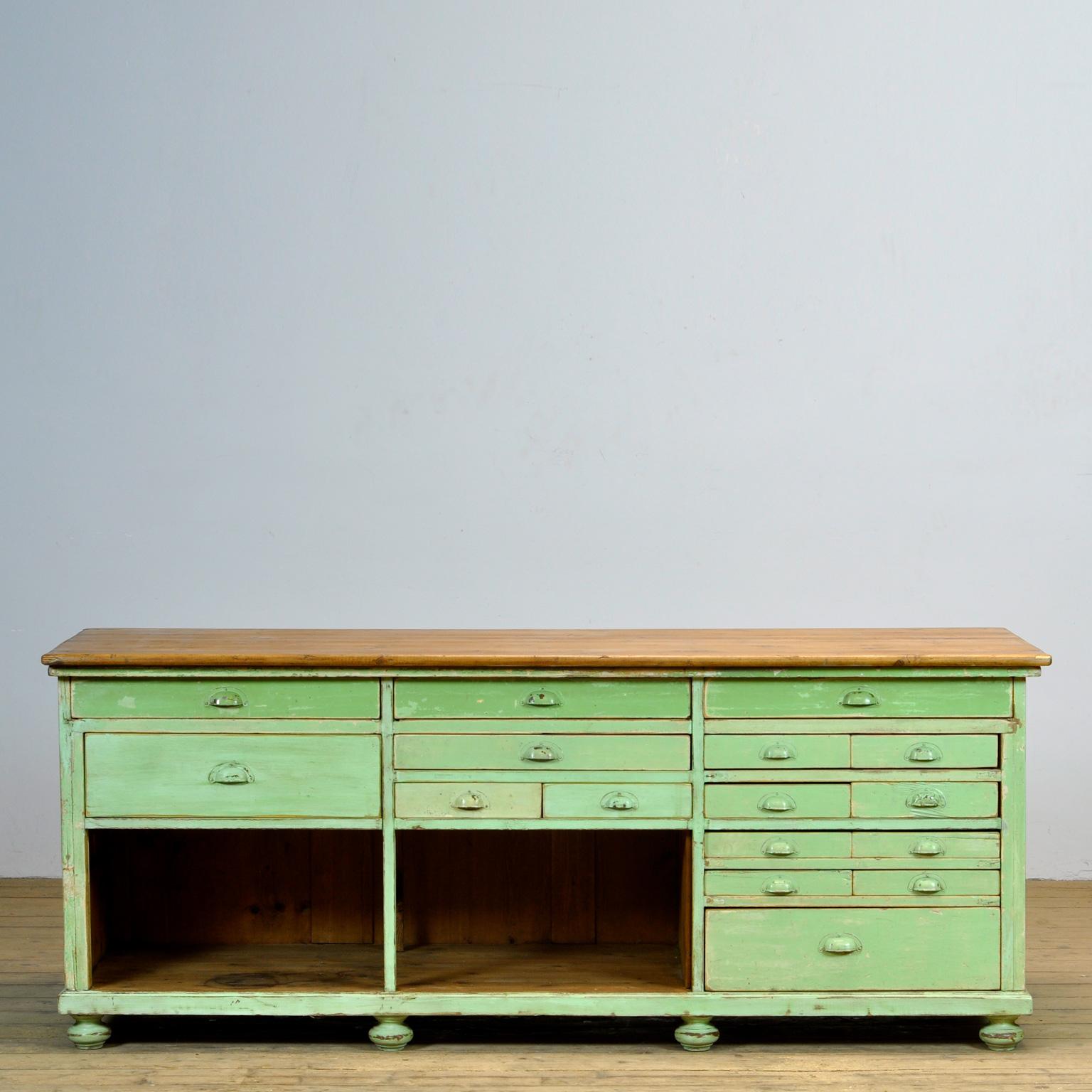 Pine work table from the 1930s. The table has 16 drawers of different sizes. The top three drawers are divided into compartments. The drawers are all made with dovetail joints. Original paint.
Can be used, for example, as a sideboard or as a