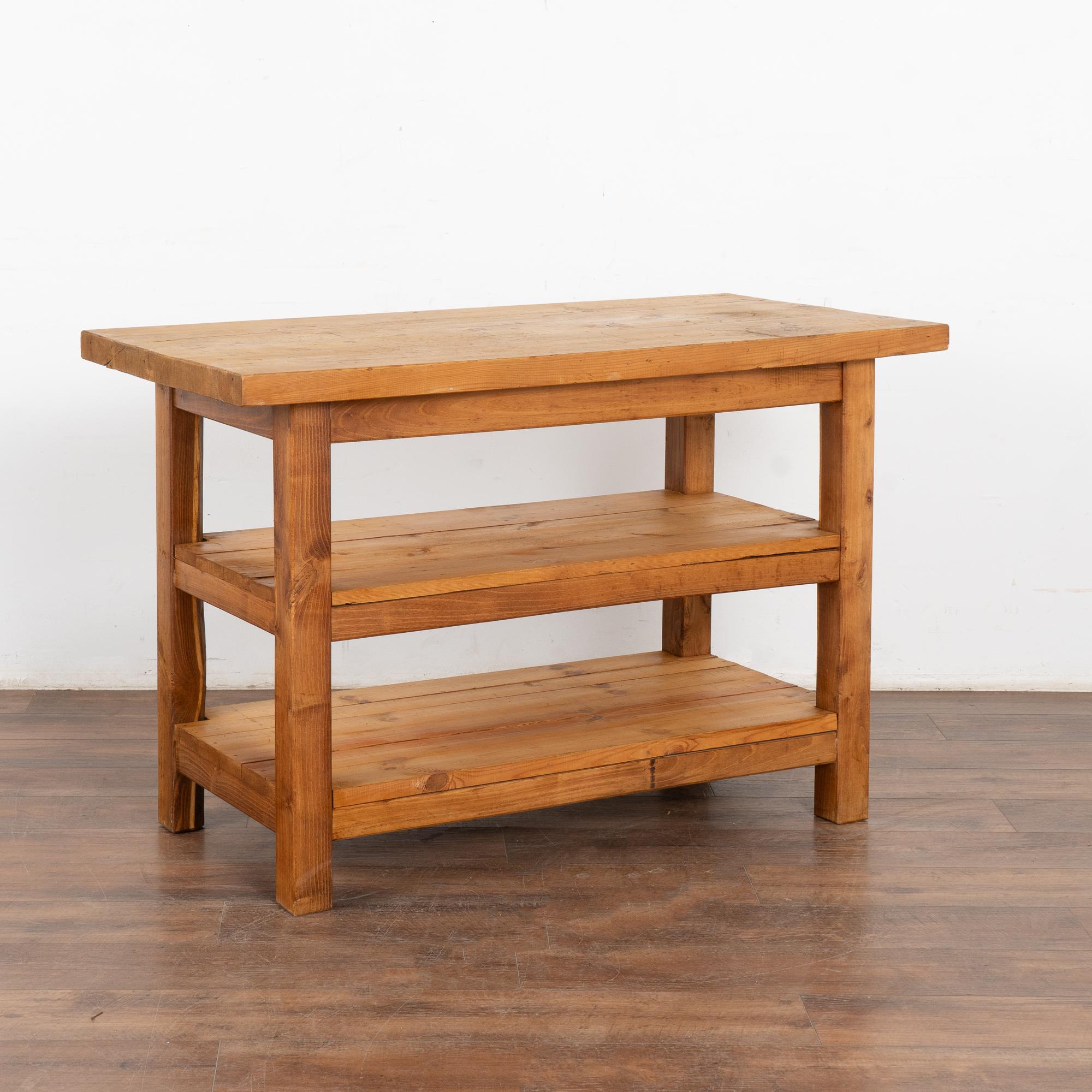 This wonderful old work table with two shelves will serve well as a small kitchen island, console or work/craft table in today's modern home. 
Refer to photos of the top to appreciate the old cracks, scrapes, nicks/gouges and stains that all reflect