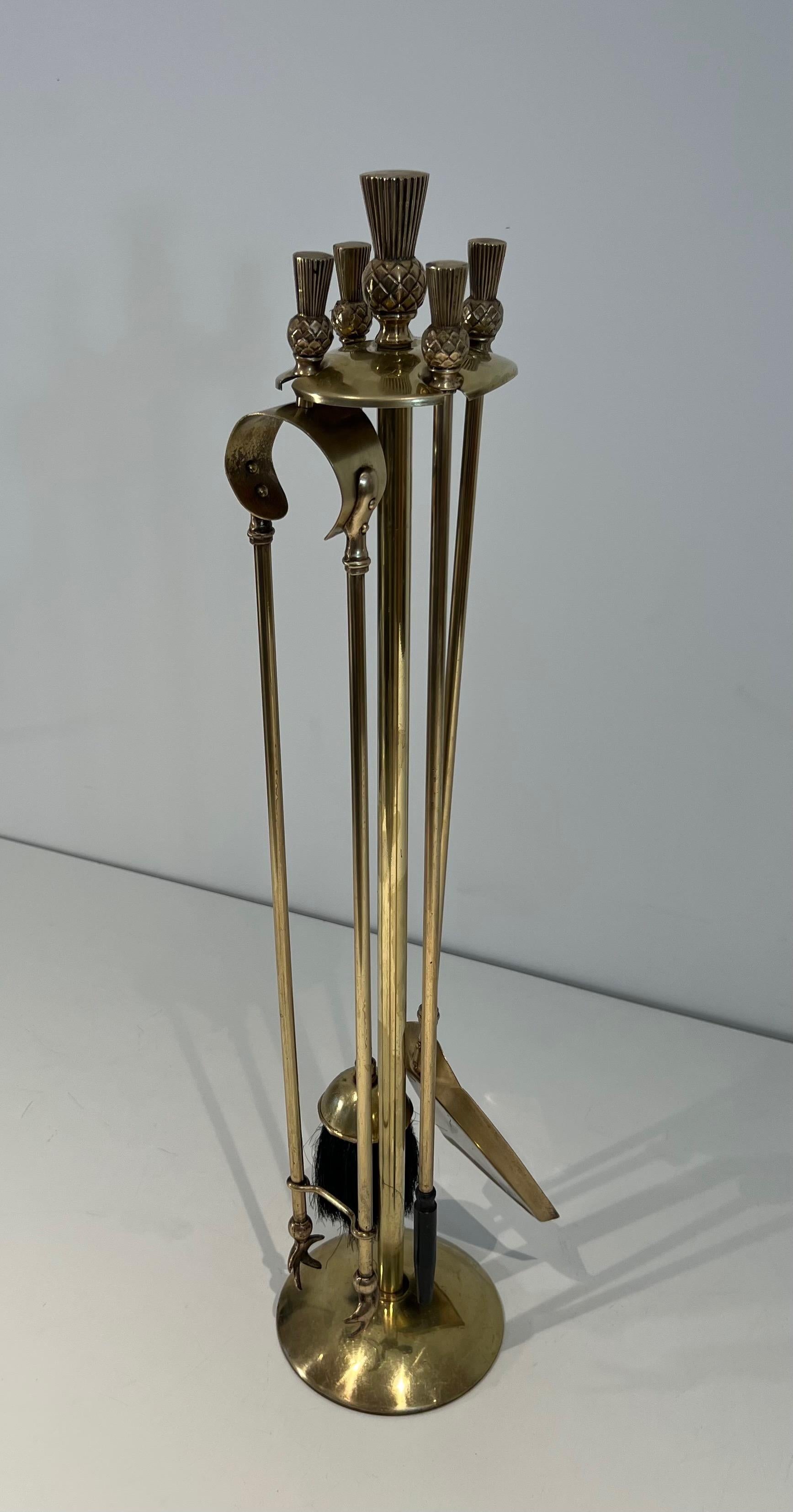 This unusual neoclassical style pineapple fireplace tools on stand is made of  brass. This is a French work. Circa 1970