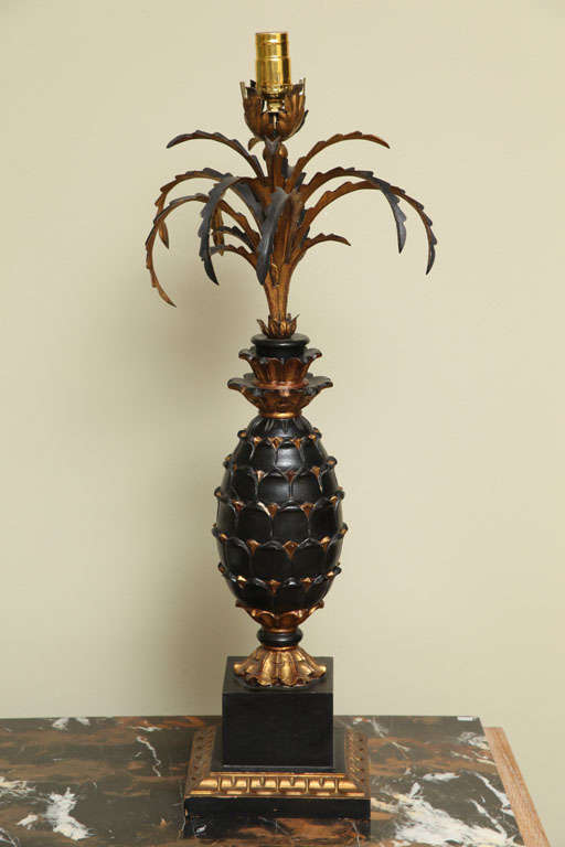 Wood sculpture in the shape of pineapple . Black lacker and gold leaf .