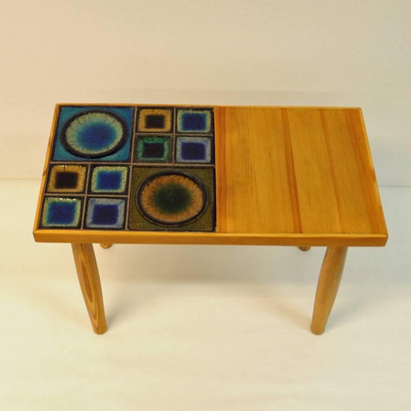 Nice little pine table with colorful ceramic tiles on the half designed by Konrad Galaaen, manufactured by Porsgrund Porselænsfabrik Norway. Good condition. Nice patterns in the wood. From the 1970s.
Measures of table: 62cm L, 33cm D x 42cm H.