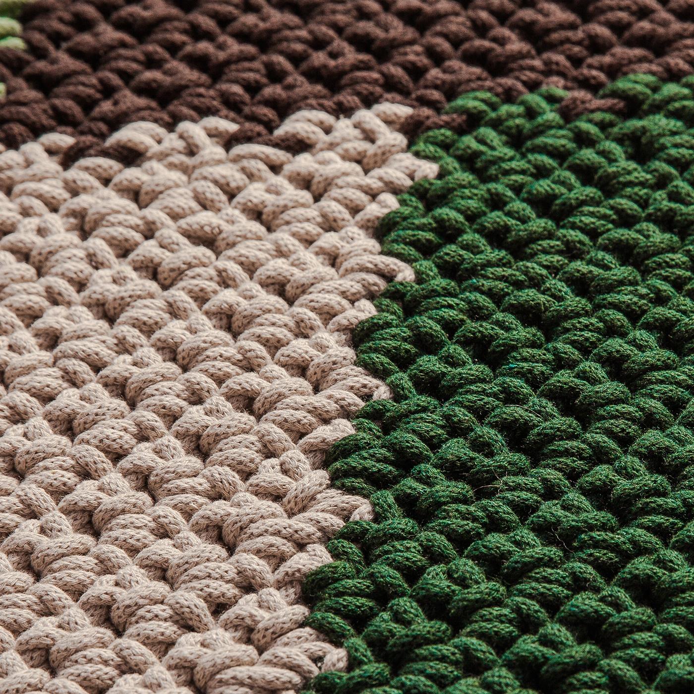 Showcasing elegant and earthy hues inspired by the pine trees typical of the city of Pineto, this exquisite runner rug is an impeccable celebration of nature. Masterfully crocheted by hand, it is fashioned of a fine and recycled cotton material that