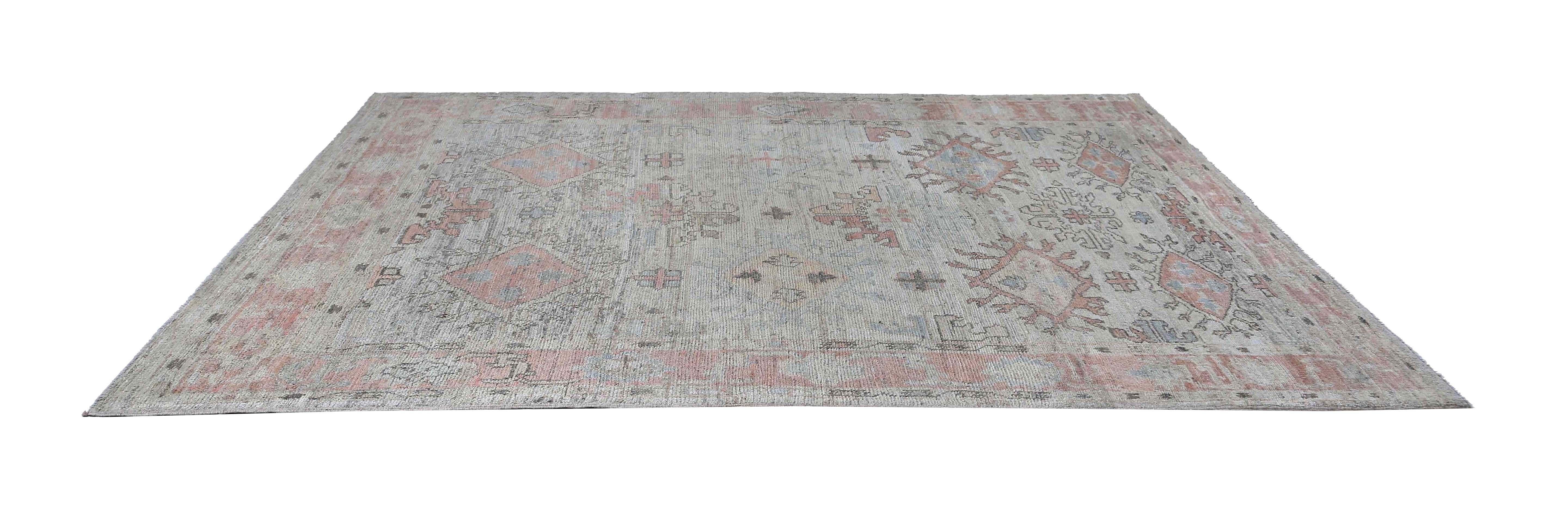 Introducing a stunning oushak rug from Turkey, measuring 6'8'' x 9'2''. This rug features a light background with beautiful pink accent tones that add a touch of elegance to any space. With its subtle yet intricate design, this rug is sure to make a