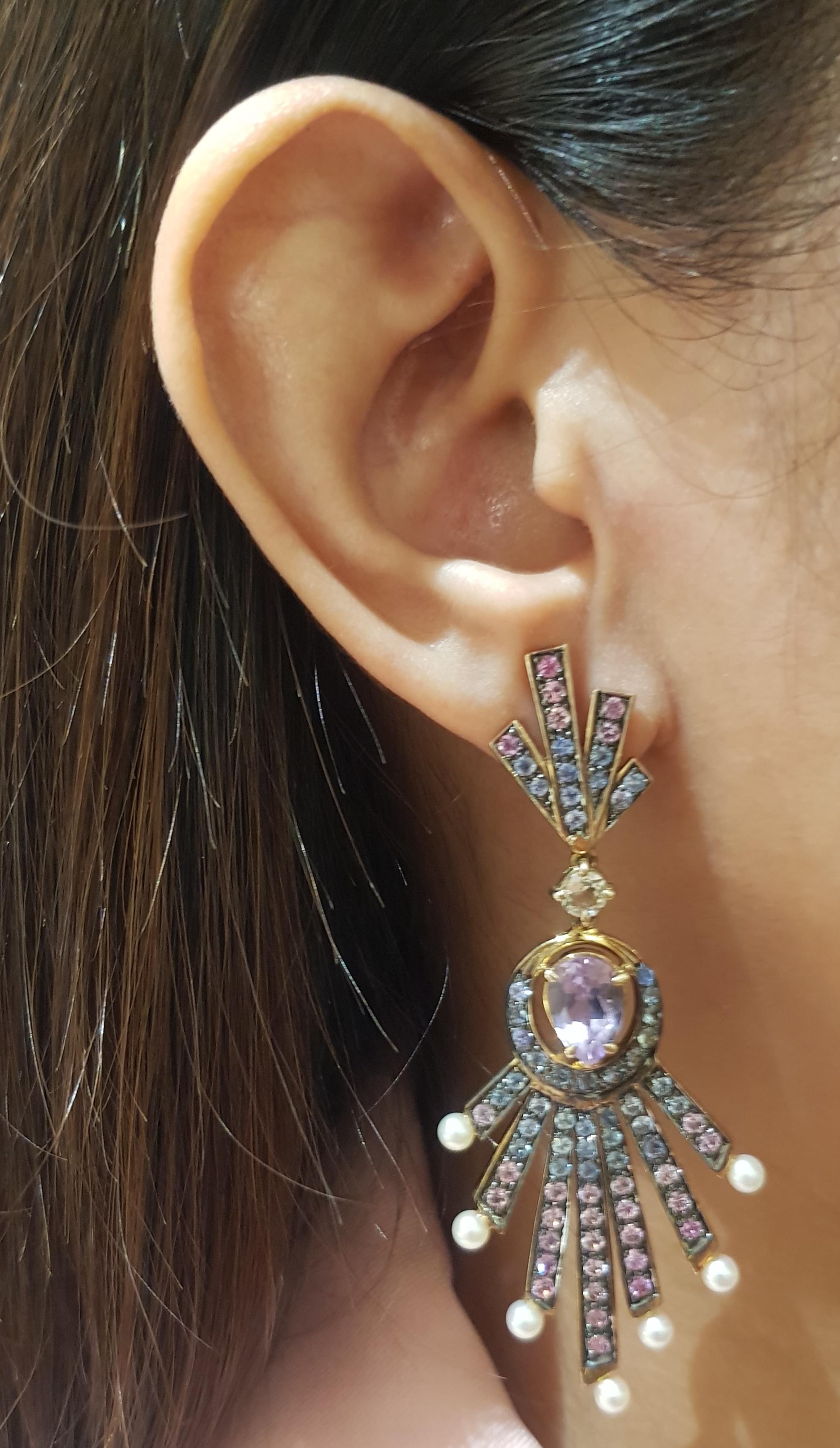 Pink Amethyst, Pink Sapphire, Blue Sapphire and Pearl Earrings set in Silver Settings

Width:  3.2 cm 
Length:7.9 cm
Total Weight: 19.3 grams

*Please note that the silver setting is plated with gold and rhodium to promote shine and help prevent