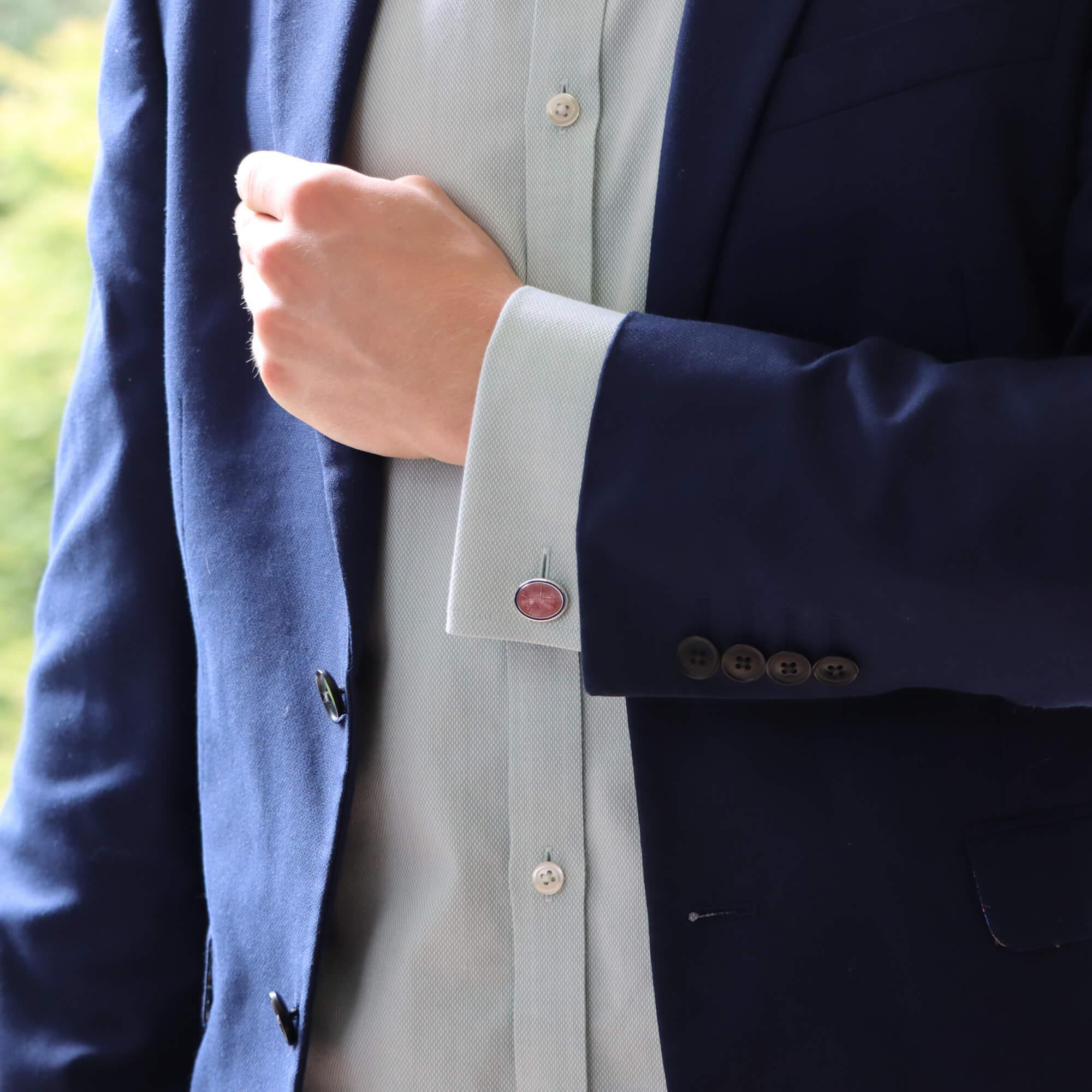 A rather interesting pair of blue and pink enamel chain link oval cufflinks set in British sterling silver. 

Each cufflink is composed of two oval faces securely connected by a chain link. Each cufflink face is hand enameled each having their own