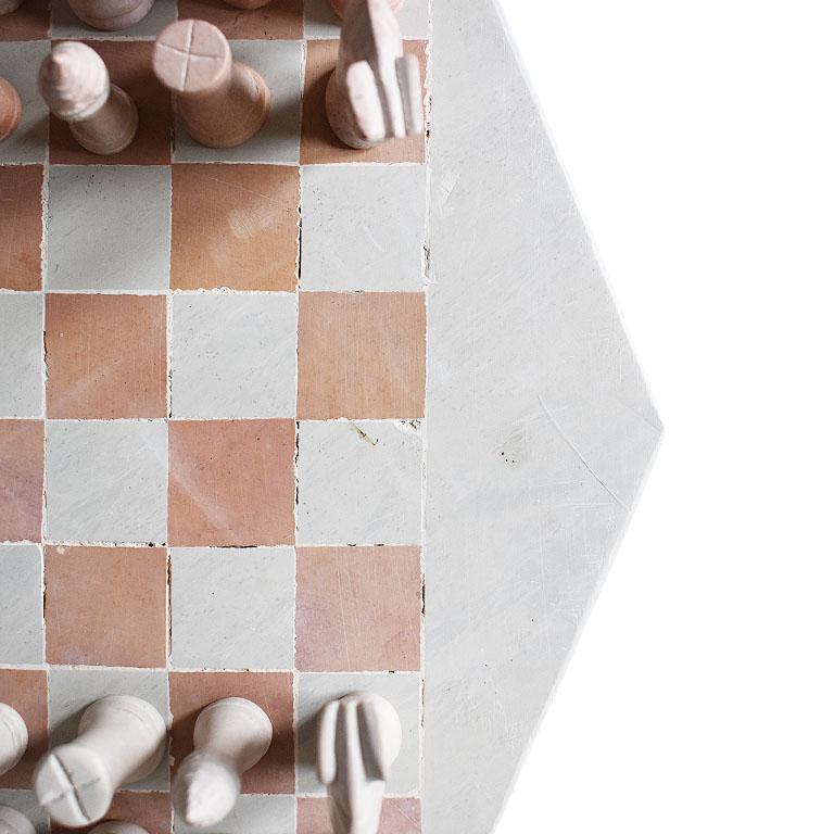 A complete chess set in pink and cream stone. This board will make a lovely addition to any coffee table or game table. The board is created from a thin stone and decorated with pink square chess squares. The exterior of the board on the top frames