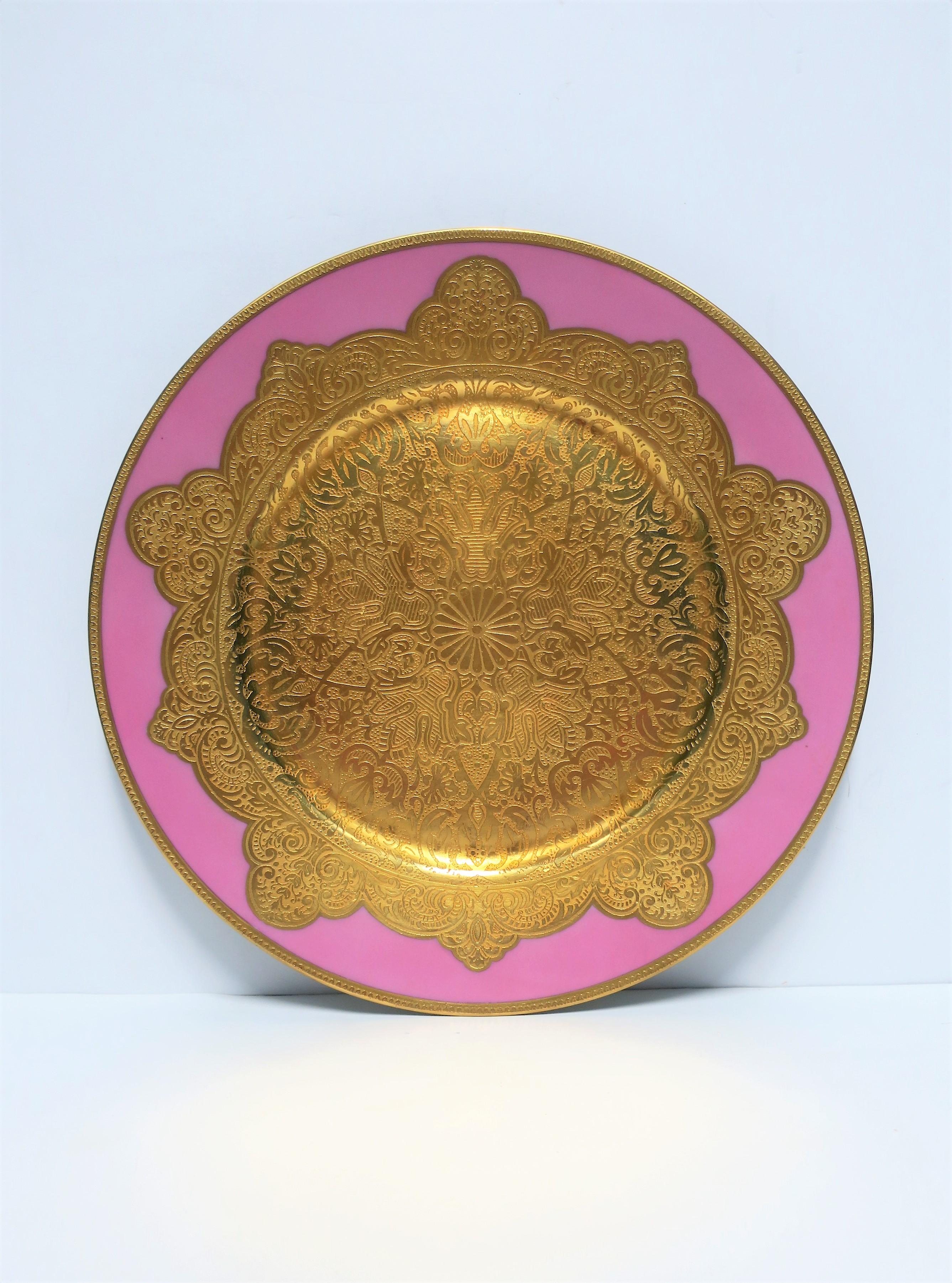 A gorgeous pink and gold gilt porcelain German dinner plate charger or wall art, circa early-20th century, Germany. Plate has a heavy gold gilt edge and center; both are embossed with beautiful detail - closeups in image #7 and 8. Plate has