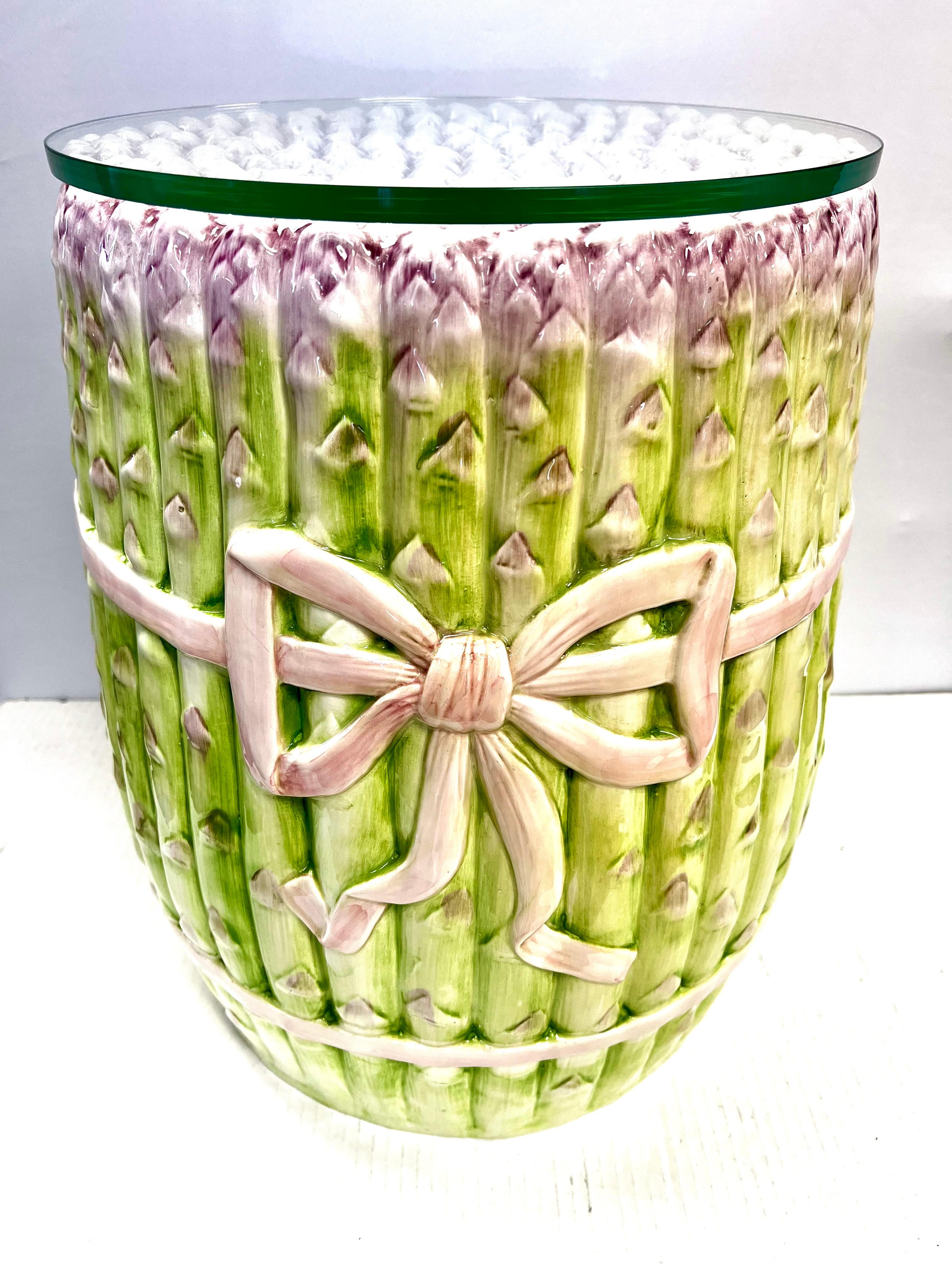 Porcelain garden seat in the form of a bunch of asparagus ties with a pink ribbon. Has removable glass top.  Made in Italy.