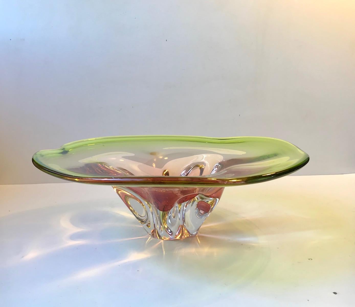 Large, monumental and heavy art glass bowl. Made from cased green main glass with a center in sculpted pink and clear glass. It shape, colors and delicacy mimics an exotic water lily. It was designed by Archimedes Seguso during the late 1950s and