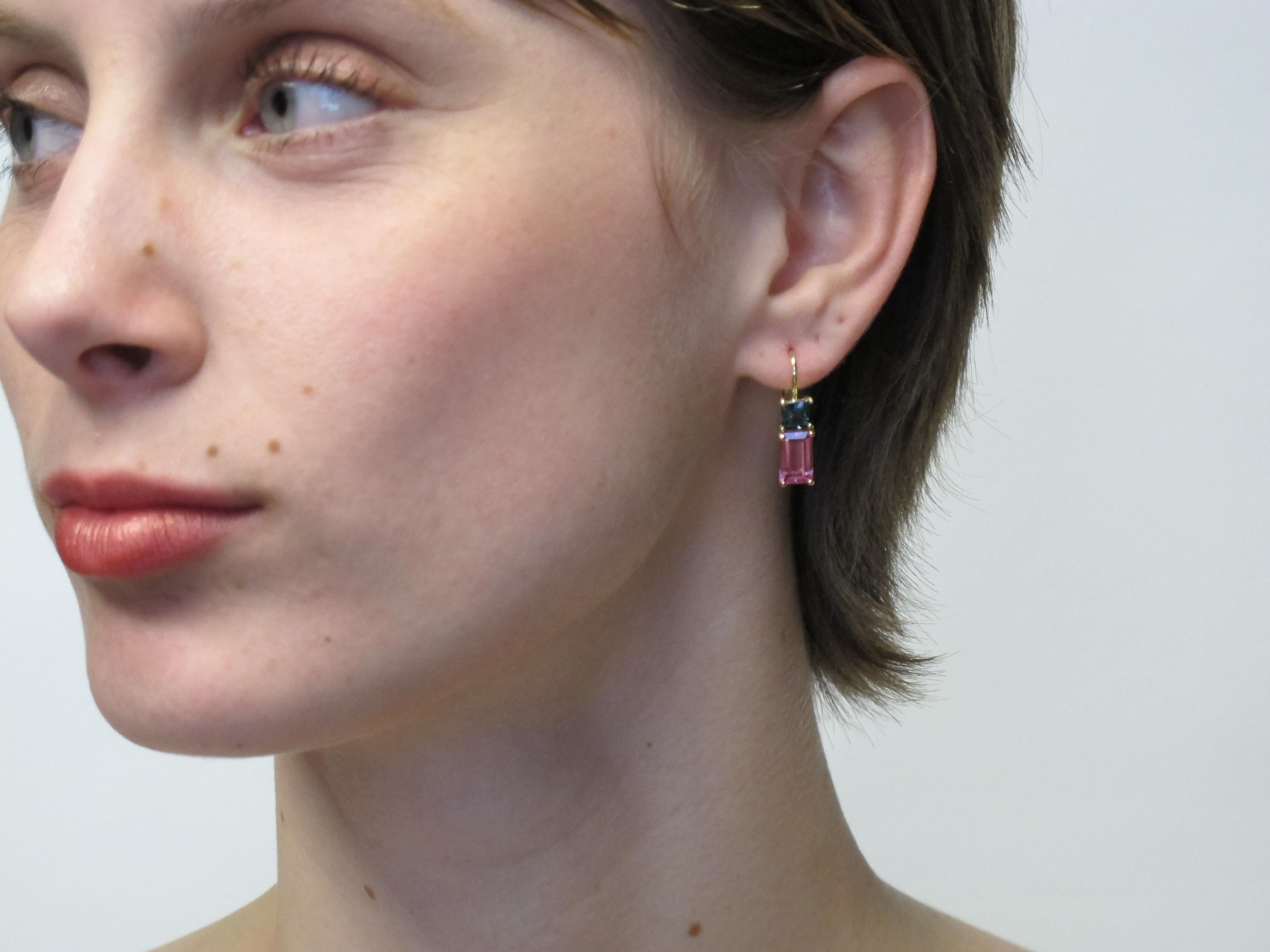 Hot pink and teal green tourmalines team up to  make a bold and happy statement in these color blocked earrings.  The rectangular and square shapes of the tourmaline further add a custom feature to these pretty earrrings. The pink tourmalines