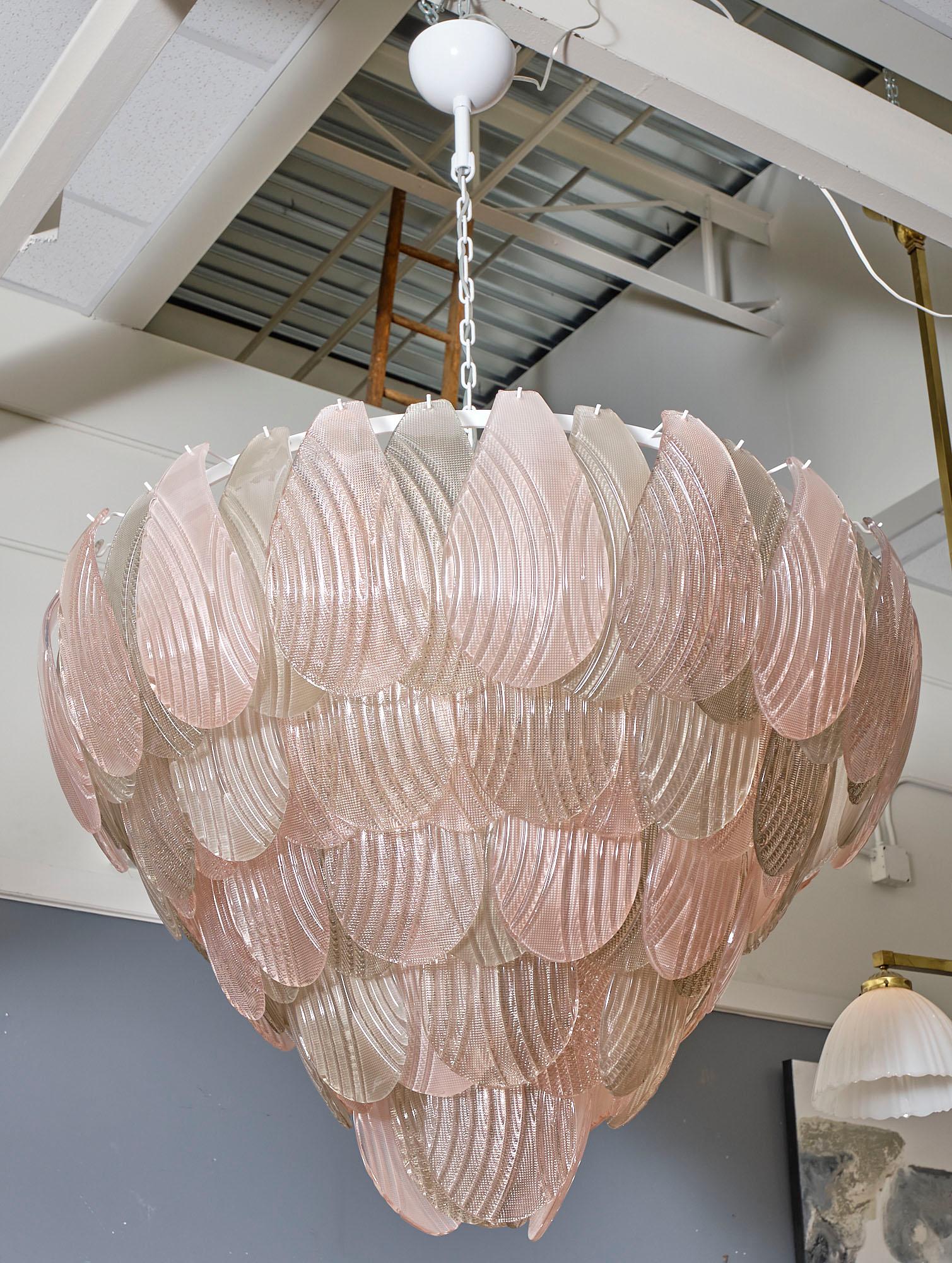 Pink and smoke Murano glass chandelier supported by a white lacquered steel structure. The array of richly textured hand-blown glass components alternate between pink and smoke in color. This piece has been newly wired to fit US standards.