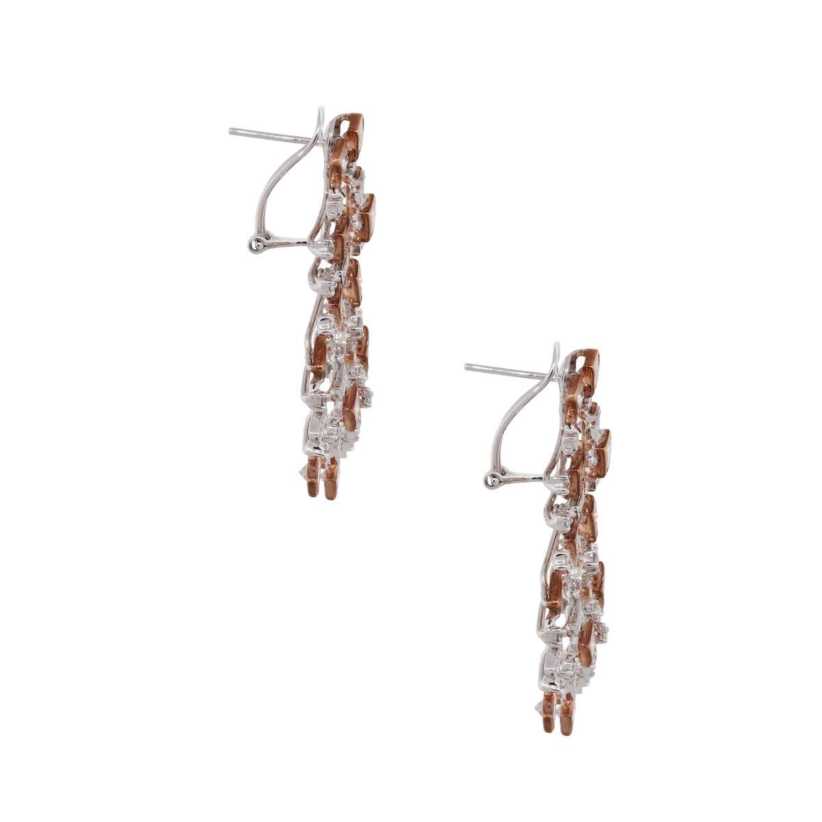 Material: 18k white and rose gold
Diamond Details: Approximately 1.12ctw of white round brilliant diamonds and approximately 5.10ctw of princess cut natural pink diamonds.
Earring Measurements: 1.68″ x 0.23″ x 0.89″
Earring Backs: Omega back
