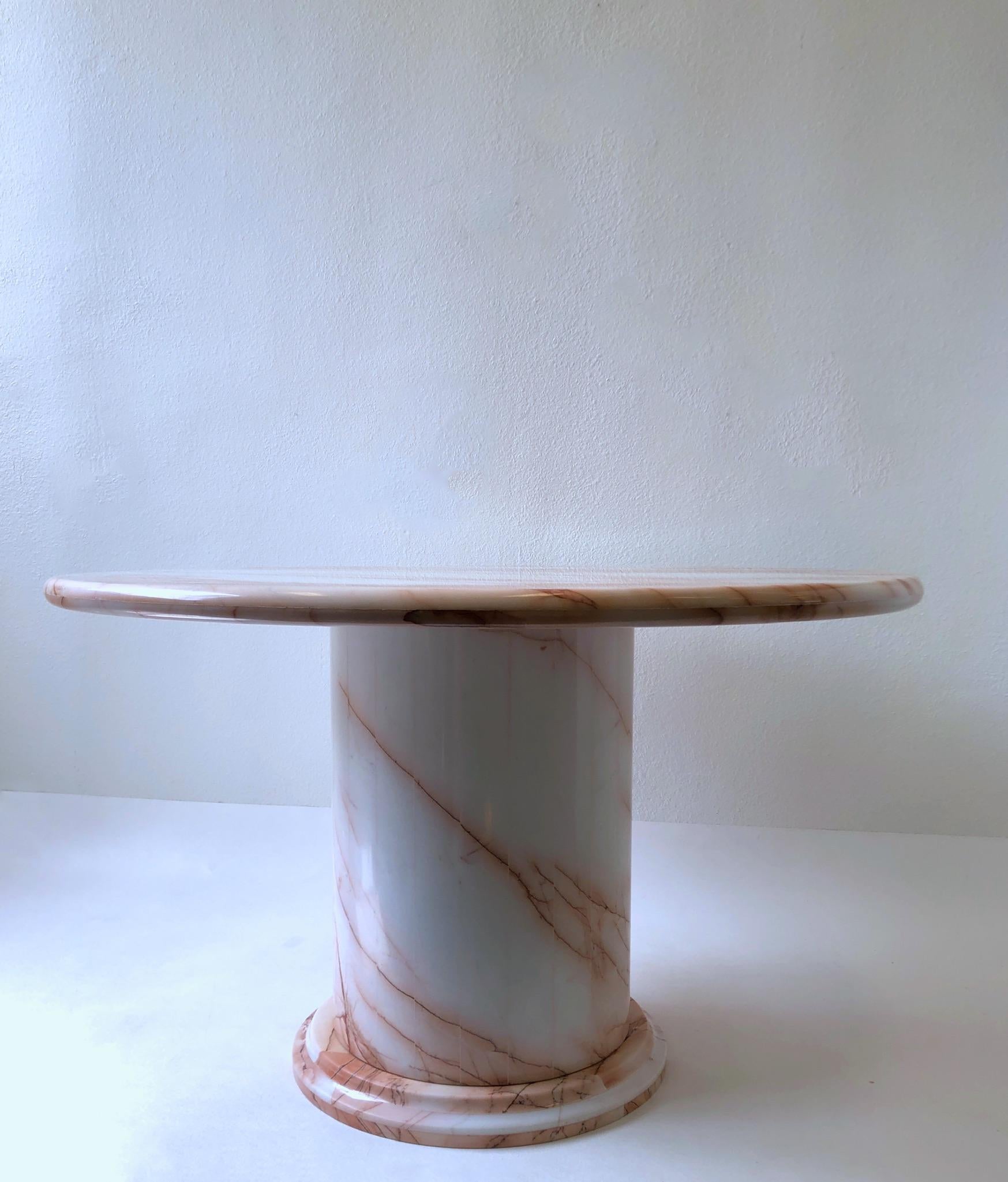 1980’s glamorous pink and white marble dining table.
It comes in three sections, the top has been newly professionally polished.
Shows minor wear consistent with age.
Measurements: 29.25” high 48” diameter.