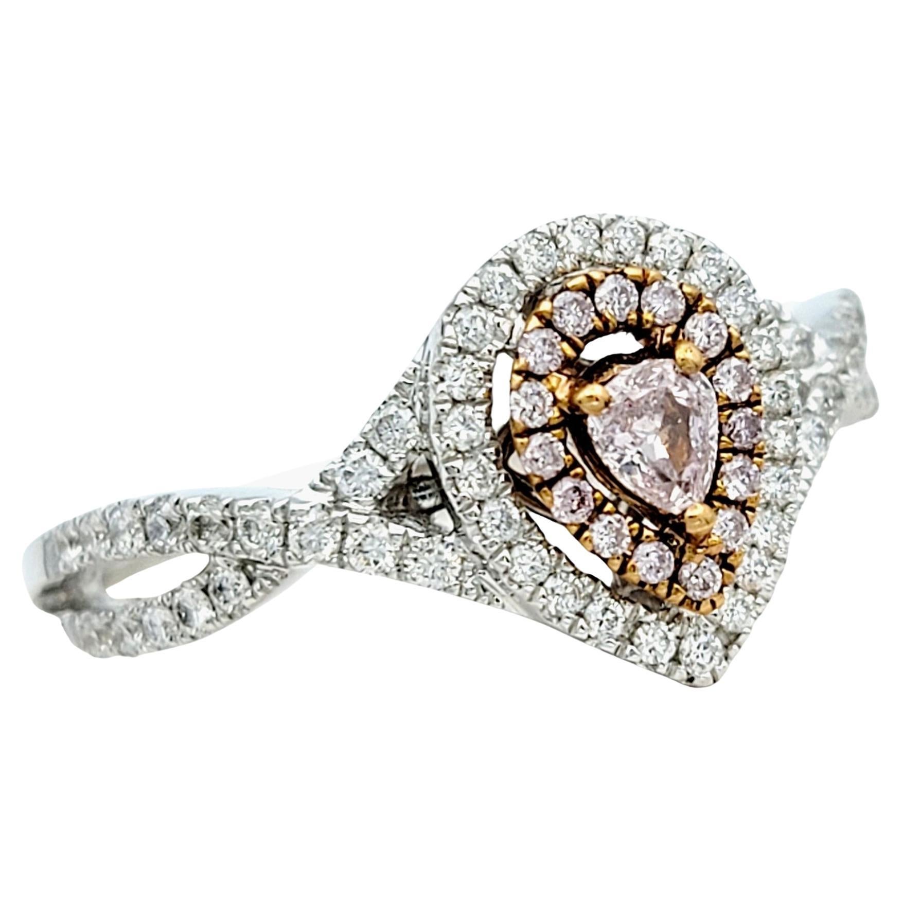 Ring Size: 7

This stunning diamond ring is crafted in lustrous 18 karat white gold, showcasing a captivating pink pear-cut diamond at its center, capturing elegance and femininity. Surrounding the exquisite centerpiece are not just one, but two