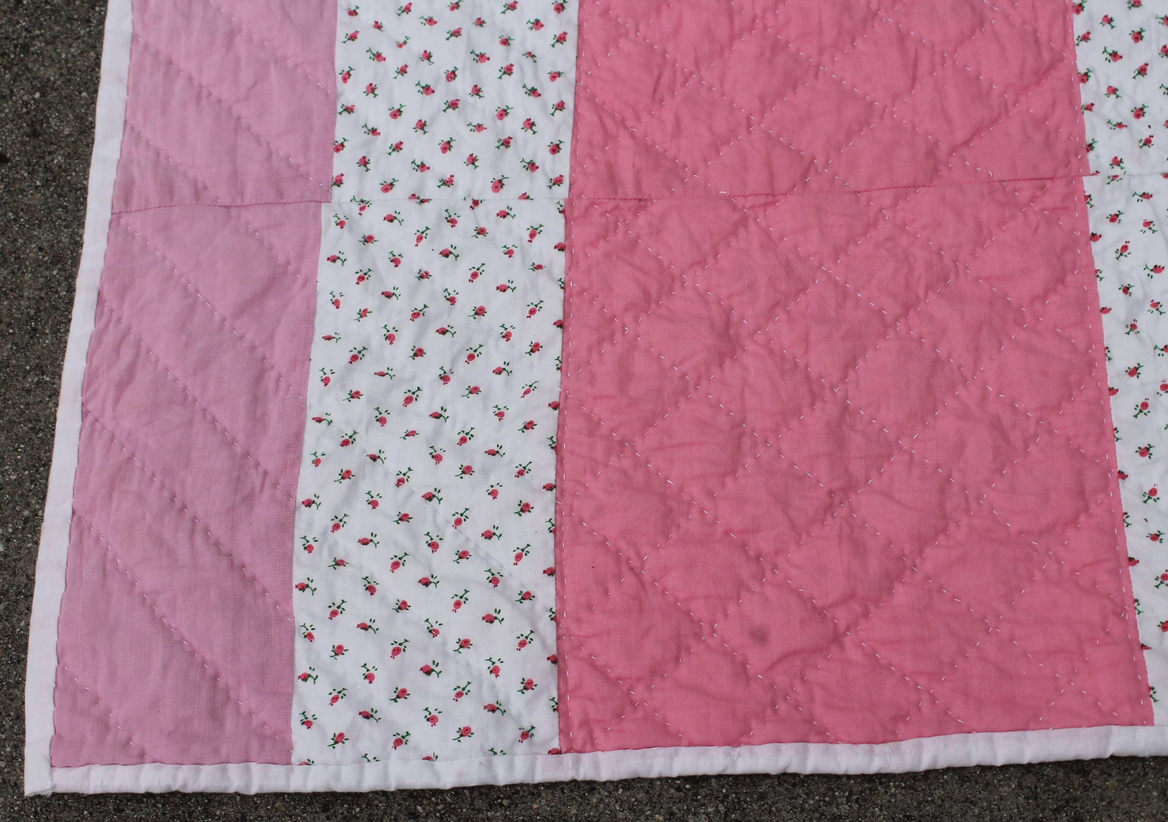 This crisp mauve and pink large flying geese quilt is in very good condition and wonderful quilting. This is a large size quilt for a king or queen bed. The quilting and piece work is the best of quality. The white ground has little calico roses in