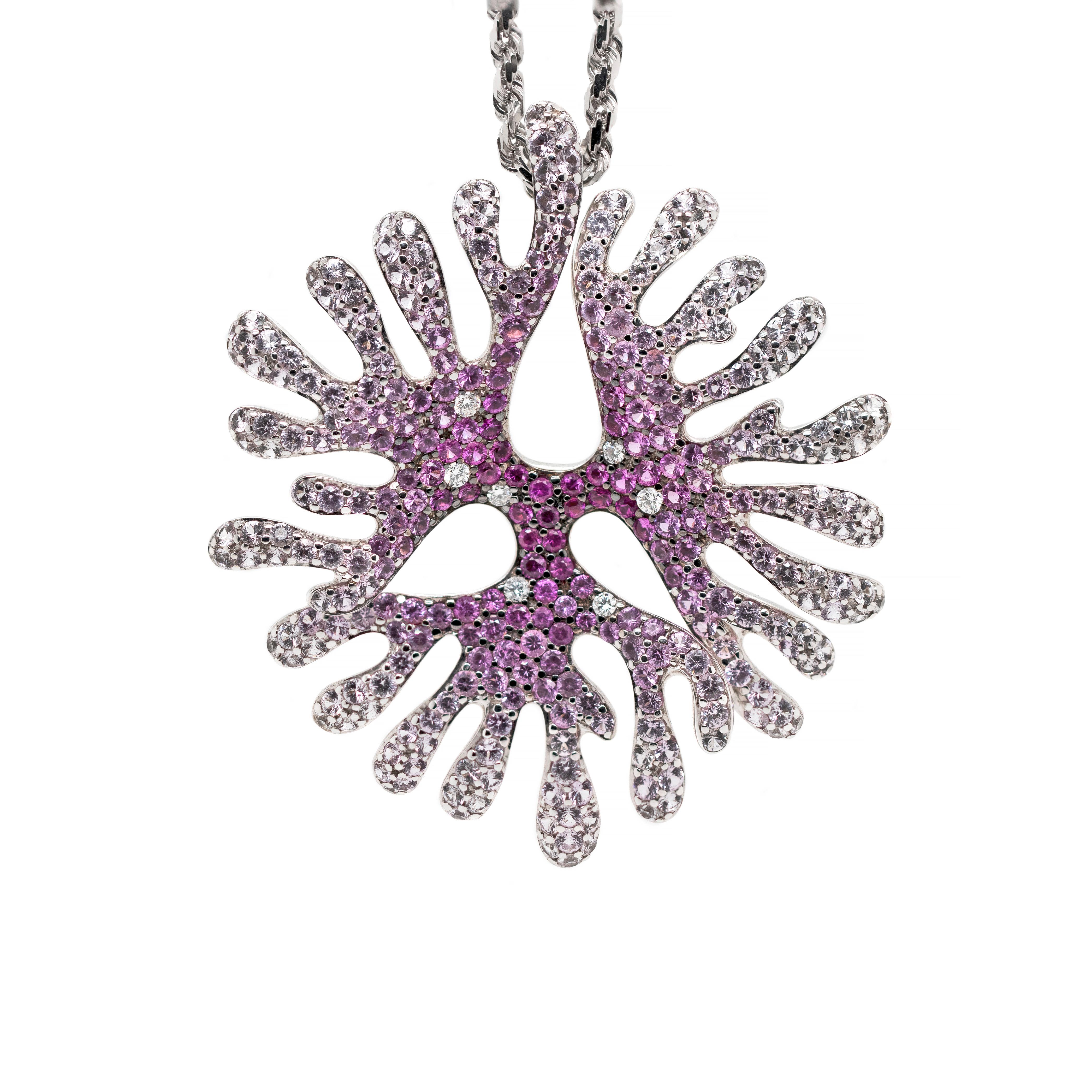 This incredible coral shaped pendant is set with a mix of beautiful pink and white sapphires weighing a total approximate weight of 5.00ct, all mounted in 18ct white gold. To accompany the beautiful sapphires, the pendant is further set with 7 round