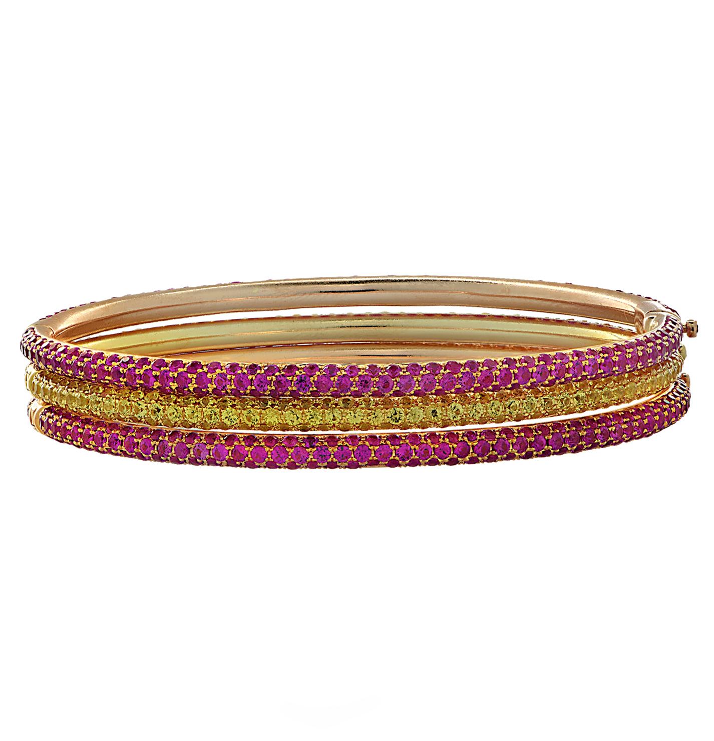 Stunning bangle bracelet set crafted in 18 karat yellow and rose gold, featuring Pink Sapphires weighing approximately 11.4 carats total and Yellow Sapphires weighing approximately 6.2 carats total. This set comprises of two rose gold bangles
