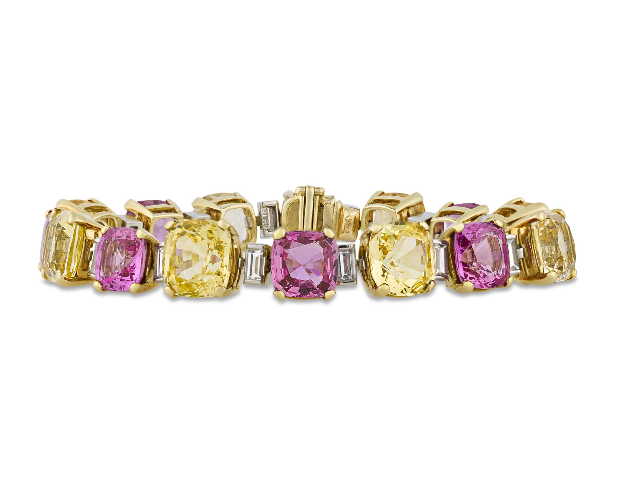 Showcasing approximately 46.00 carats of yellow sapphires and 26.00 carats of pink, the rare gems in this incredible bracelet display the vibrant and desirable hues for which precious colored sapphires are famous. Interspersed with baguette-cut