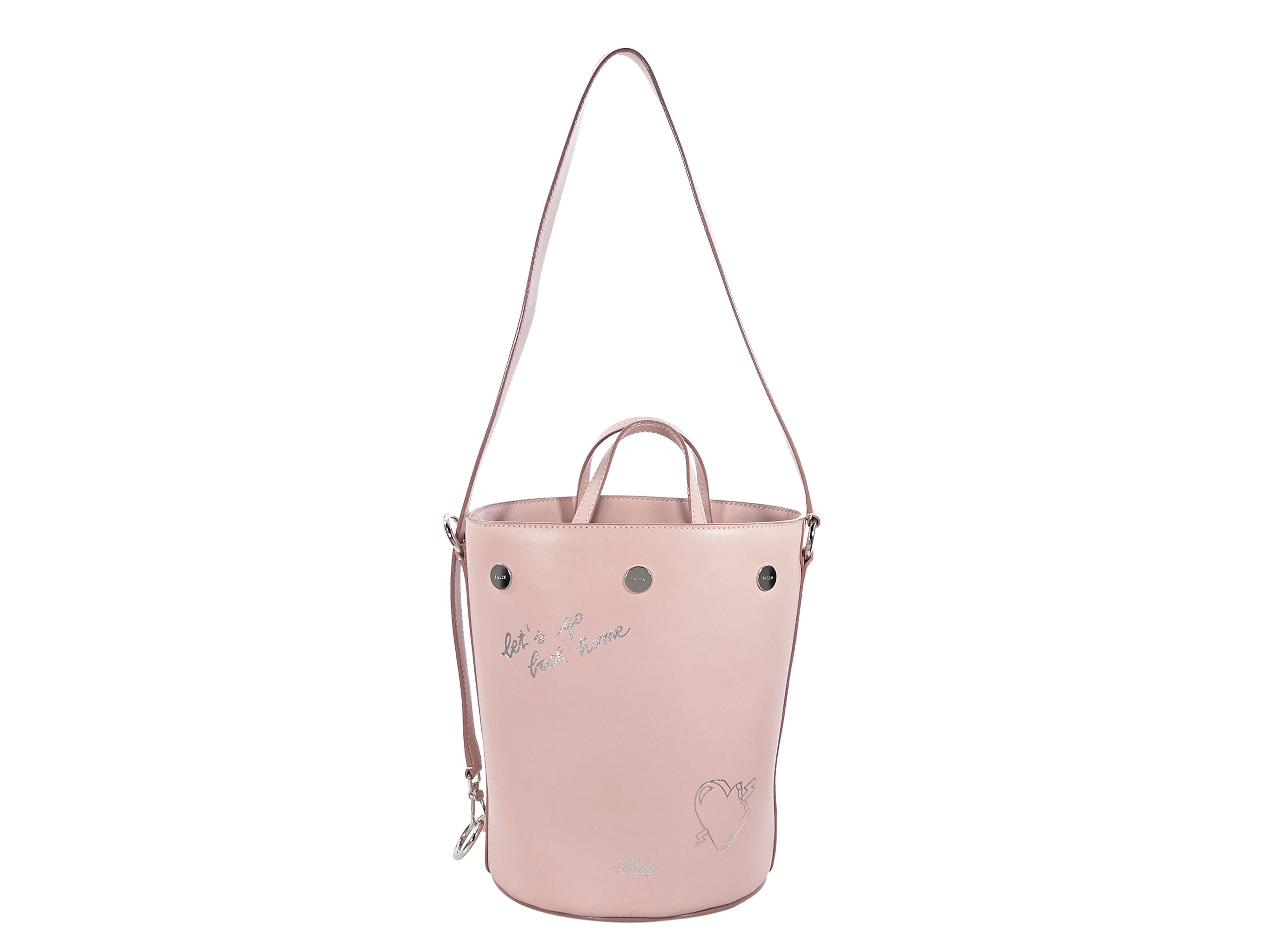 Product details:  Pink leather bucket bag by Bally.  Dual carry handles.  Adjustable shoulder strap.  Top drawstring closure.  Silvertone hardware.  7