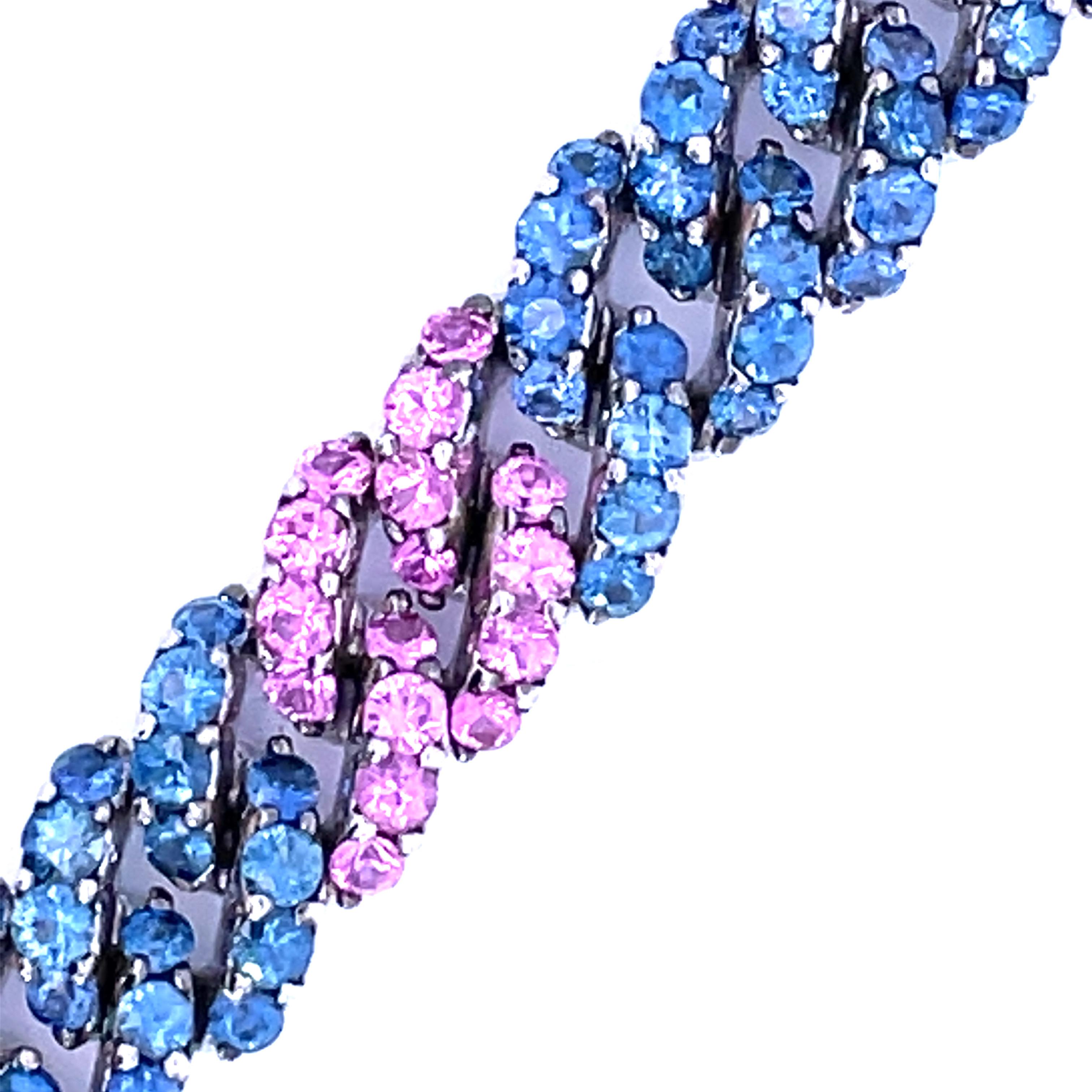 An impressive Curb Link Bracelet set with natural pink and blue sapphires set in 18kt white gold.

160 natural blue sapphires weighing 14.90ct total weight

64 natural pink sapphires weighing 5.98ct total weight

18kt white gold, 49.8 grams

0.44