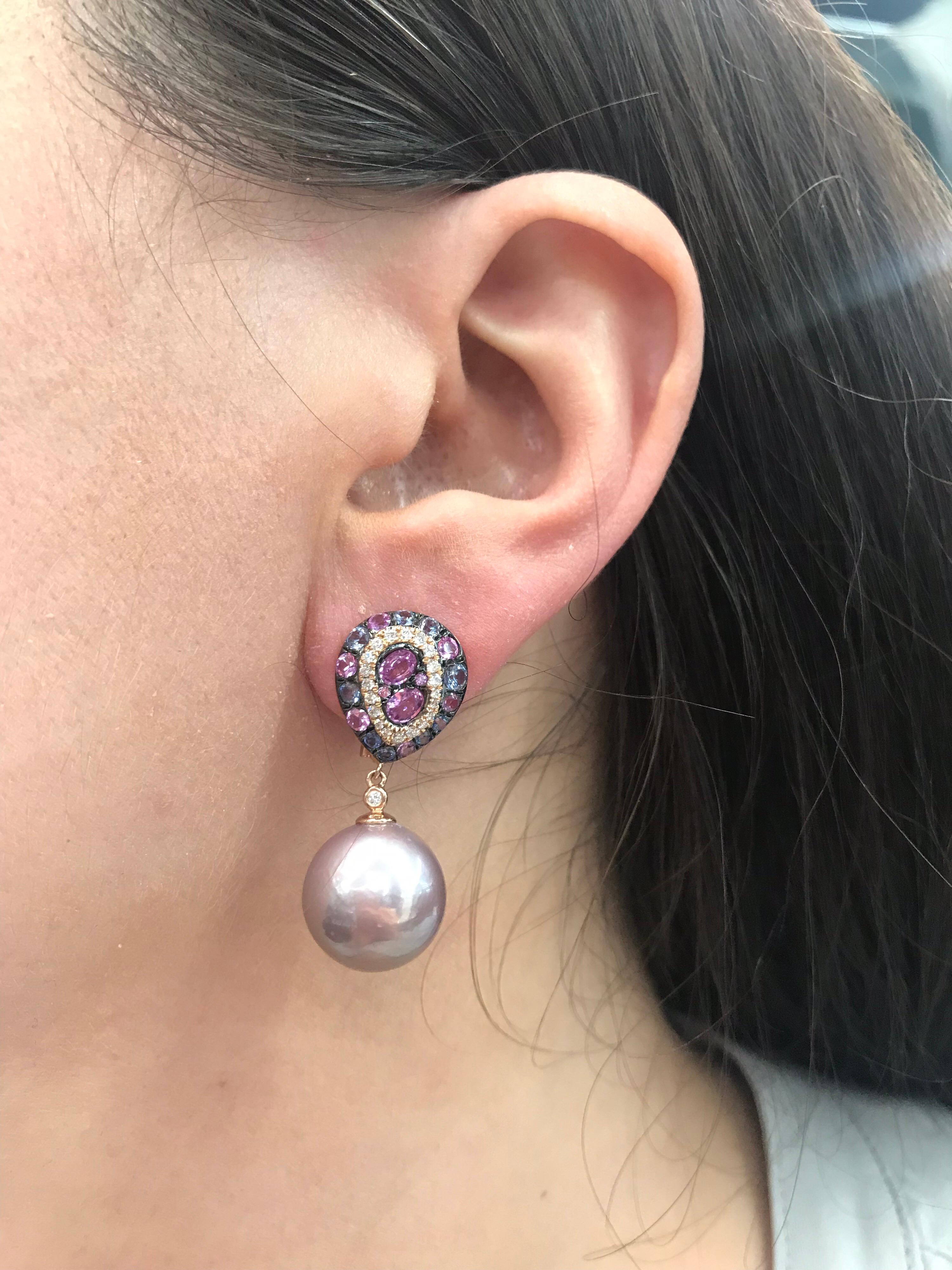 18K Rose Gold drop earrings featuring a cluster of blue sapphires, 0.97 carats, and pink sapphires, 1.41 carats, with round brilliants weighing 0.31 carats. Comes in white South Sea Pearls or Pink Freshwater pearls measuring 13-14 mm. 
Price