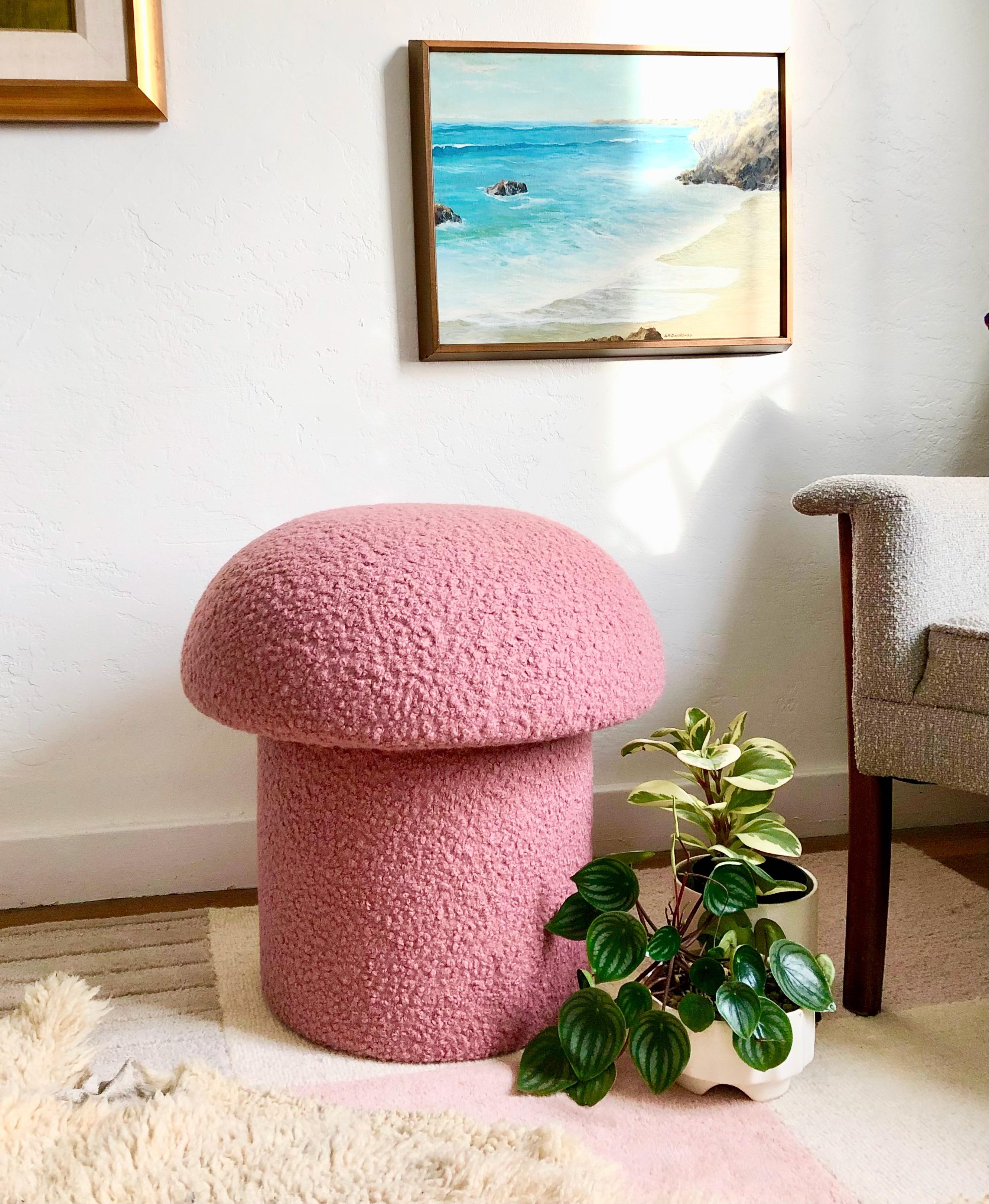 A handmade mushroom shaped stool, upholstered in a pink colored curly boucle fabric. Perfect for using as a footstool or extra occasional seating. A comfortable cushioned seat and sculptural accent piece.
Mushroom ottomans are made to order,