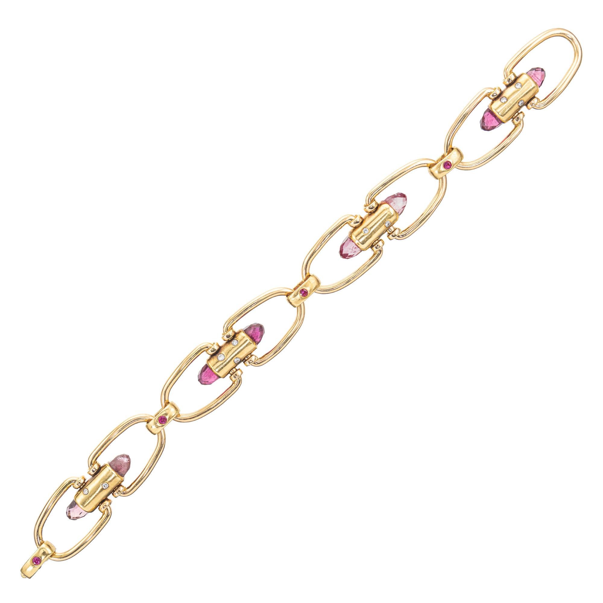 Pink Briolette Tourmaline Ruby Diamond rose gold link bracelet, a truly exquisite piece. This bracelet is a harmonious blend of delicate pink tourmaline, ruby and round diamonds, all set in lustrous 18k rose gold tubes and links. The design features