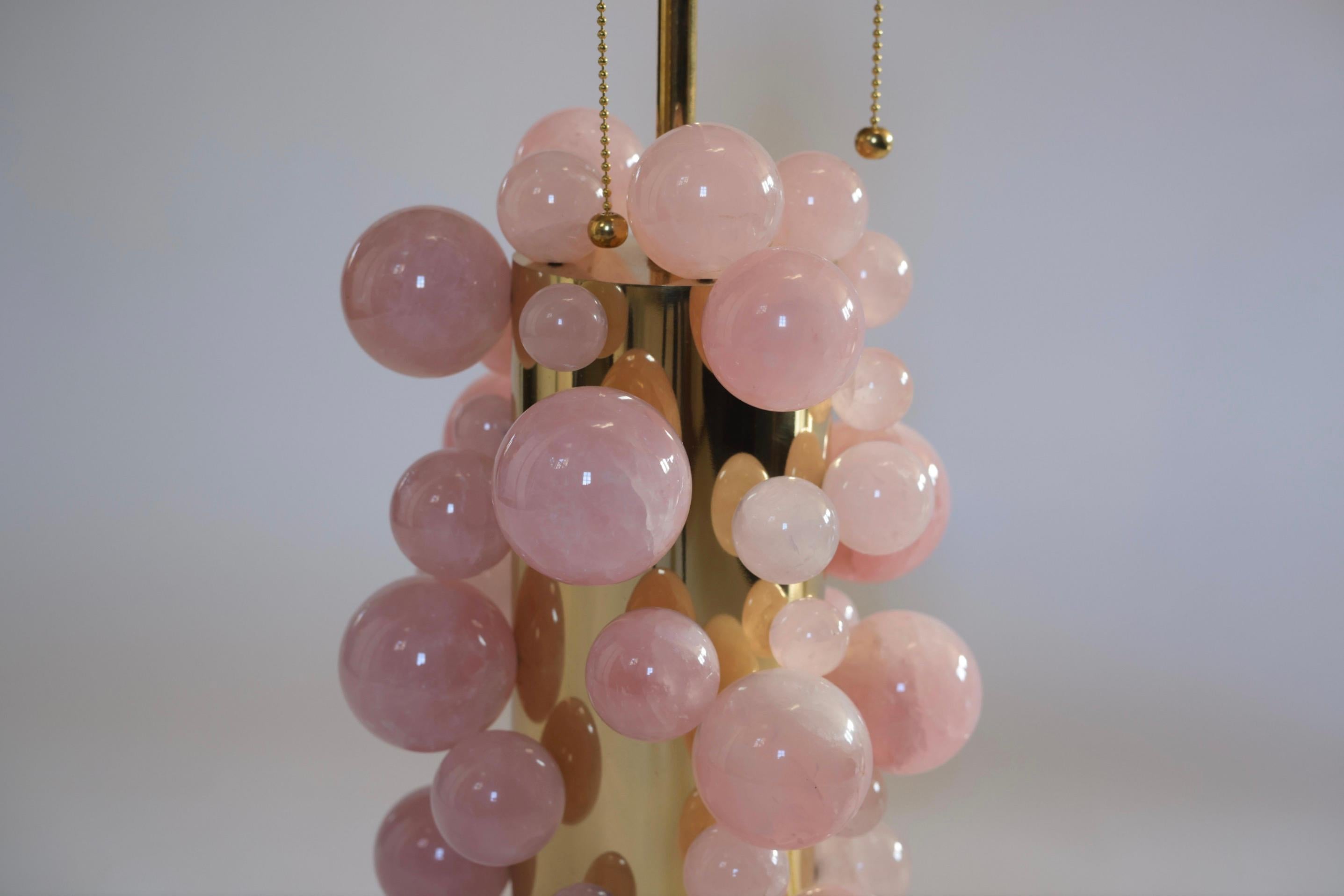 Pink rock crystal bubble lamp with polished brass finishes, created by Phoenix Gallery, NYC. Measures: To the rock crystal part 13in / H. Overall height 24.5 inches High, Lampshade is not included