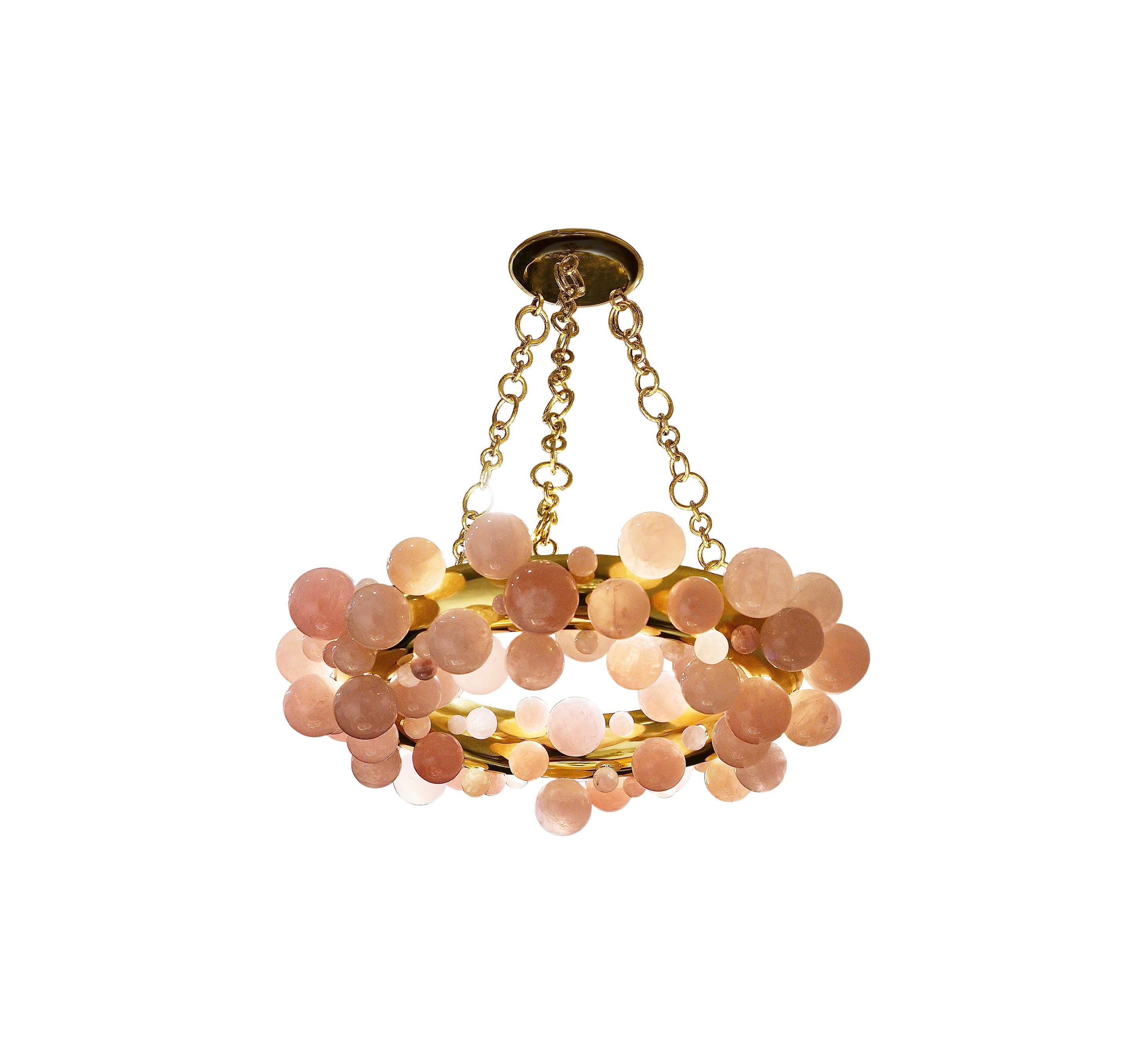 A pair of pink bubble ring rock crystal chandeliers with polish brass frame. Created by Phoenix Gallery, NYC.
Each chandelier install 10 sockets. Use 60w LED warm light bulbs. Total of 600w. 
Custom size and metal finish upon request.
 