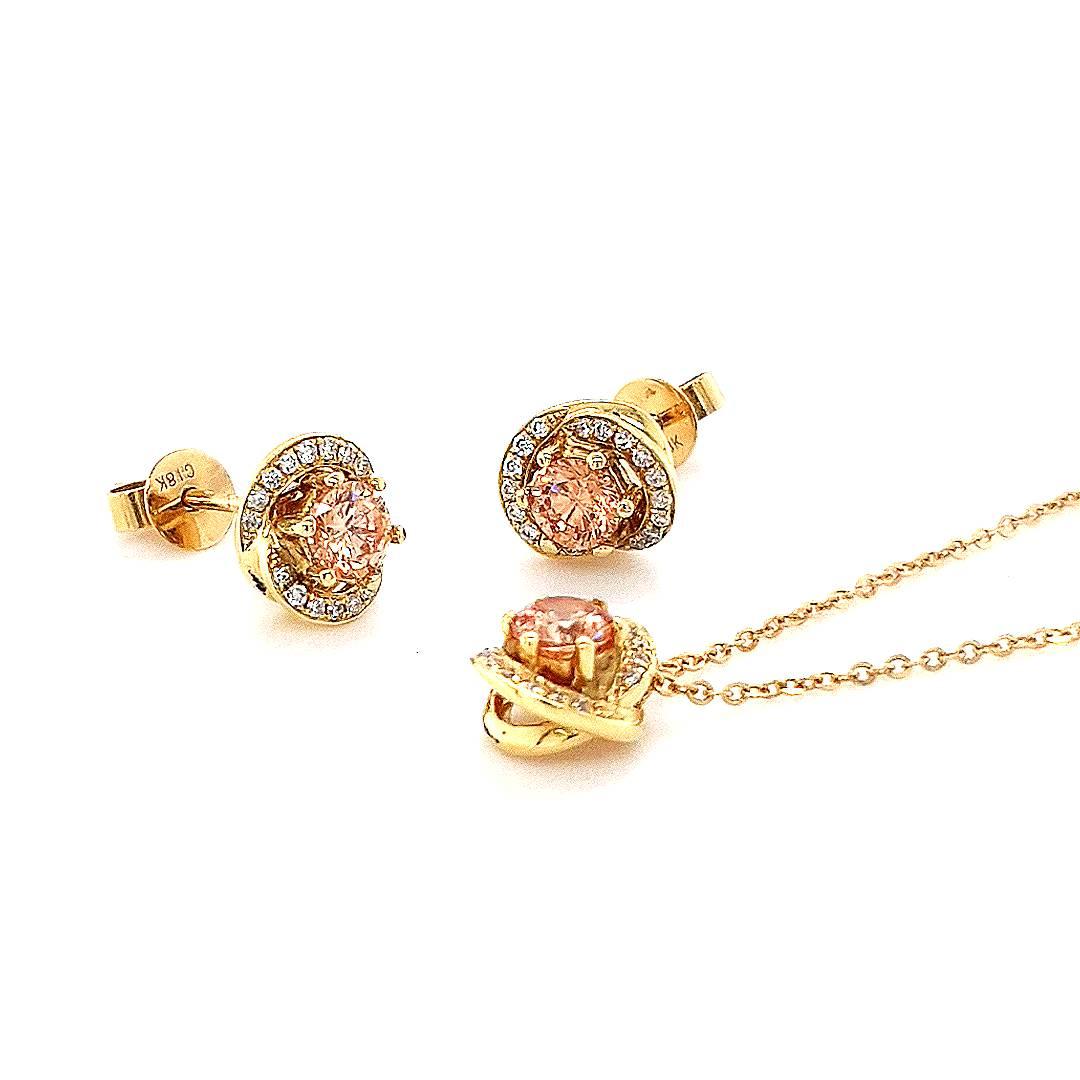 The exquisite Aurora Pendant and Earrings Set showcases a stunning series of pink champagne diamonds, each elegantly framed by a twisted halo of diamonds, set in lustrous 18ct yellow gold. Adorn yourself in the celestial allure of these finely