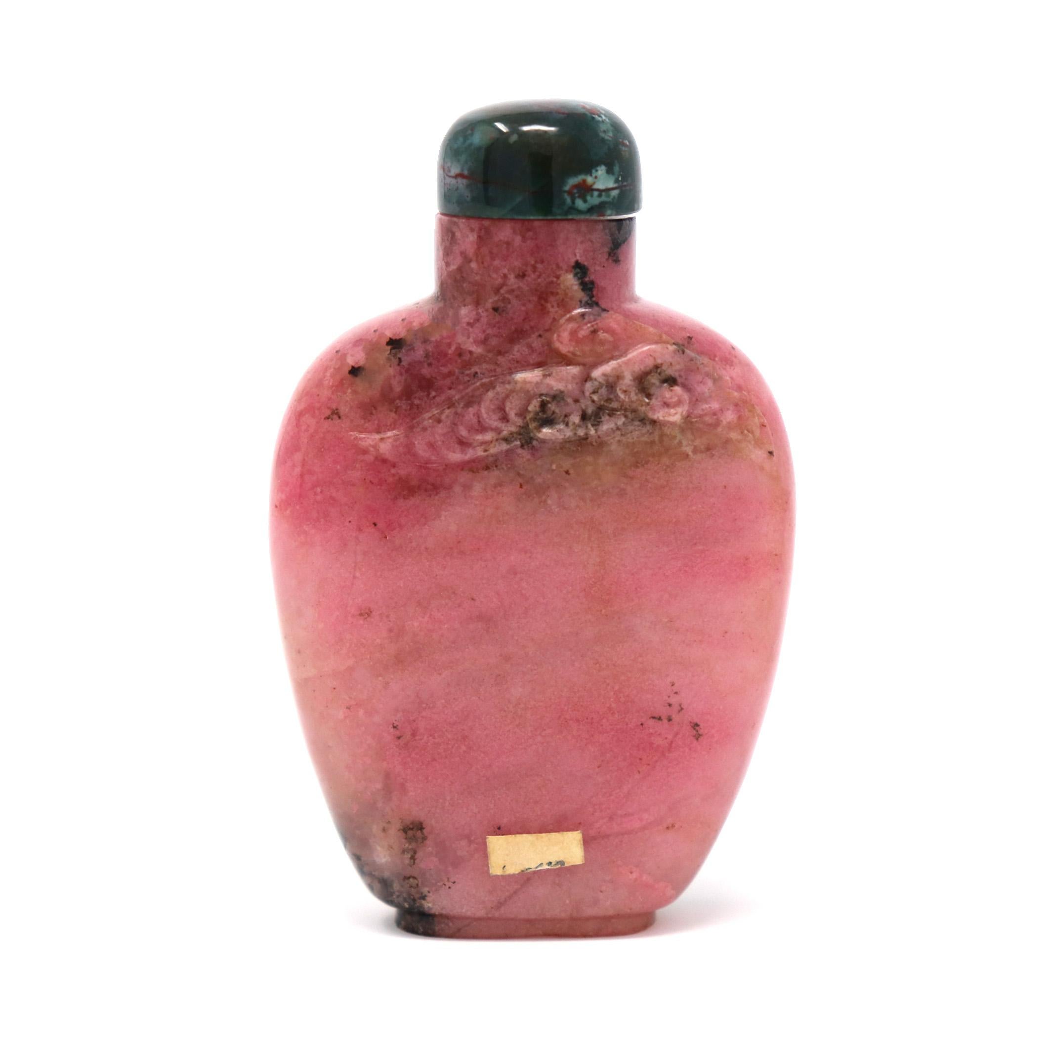 Chinese Rhodonite snuff bottle, a soft pink and black combination of the rhodonite material of flattened and tapered spade form, rounded shoulder, short neck, flat mouth rim, narrow aperture, adequately hollowed, short oval foot with countersunk