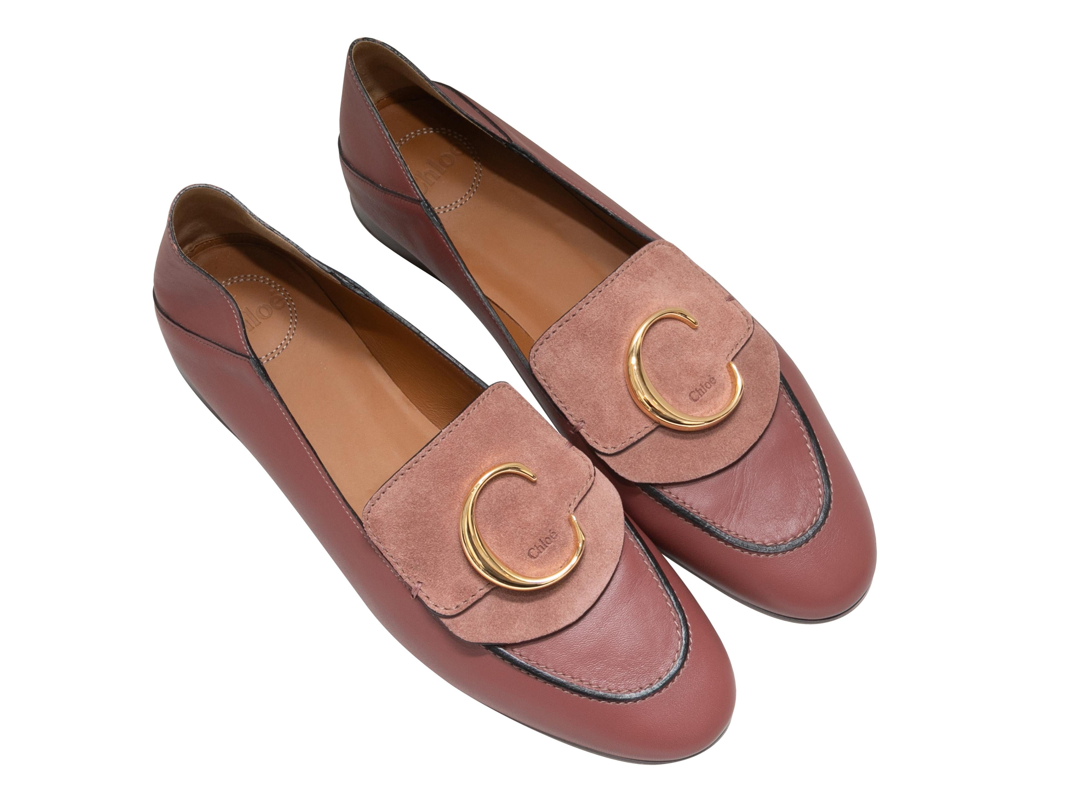Product Details: Pink leather and suede logo loafers by Chloe. Gold-tone hardware. Stacked heels. 0.5