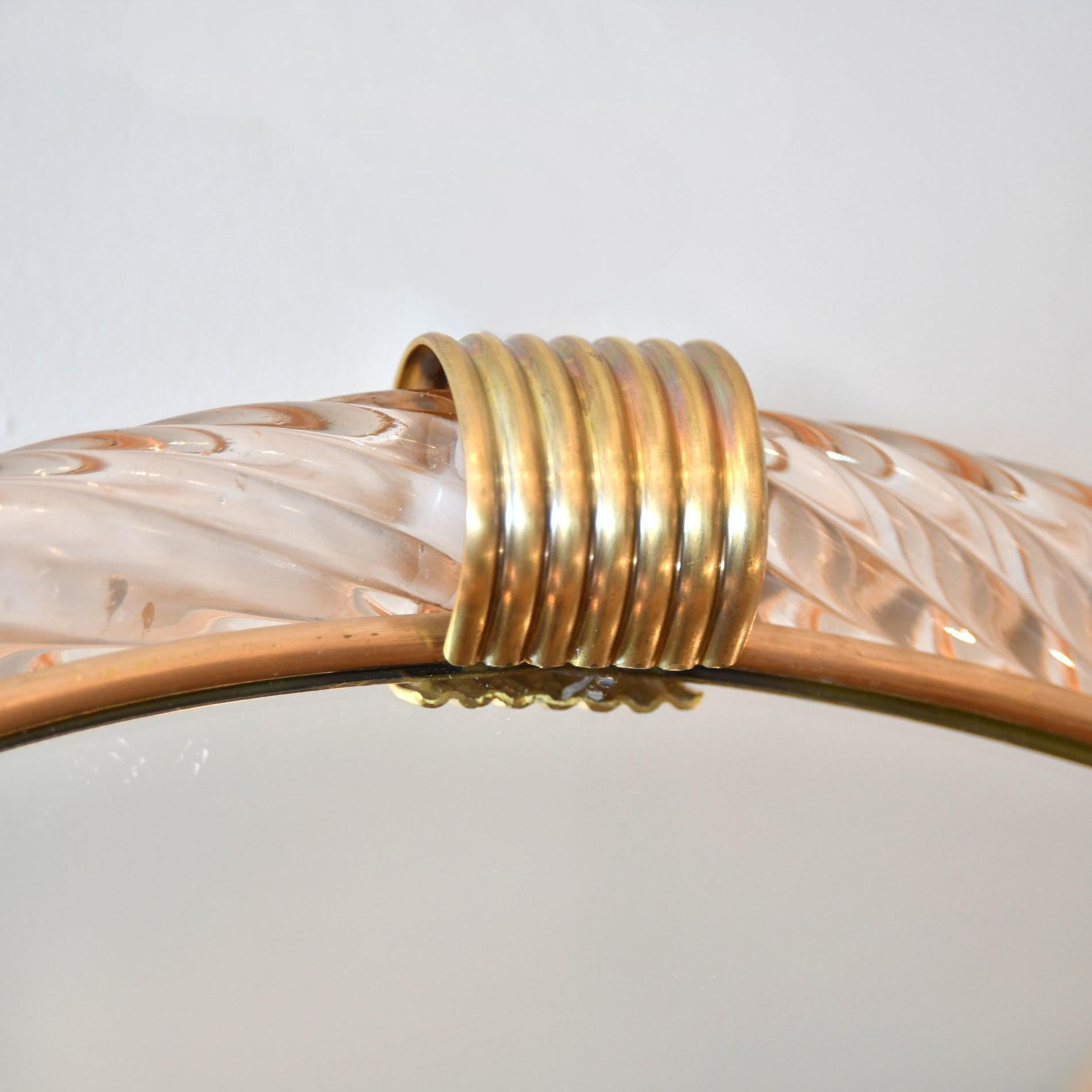 Palest pink ribbed hand blown Murano glass circular mirror with two brass fluted clasps at the top and bottom, the inner edge lined with slender brass filet.

Also available in pale blue/green.

6 week lead-time if not in stock.