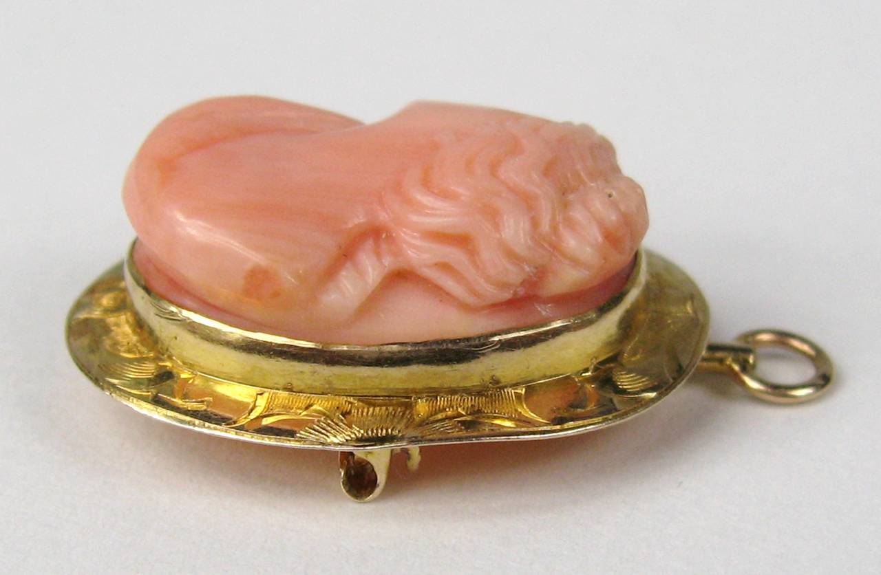 Stunning lady that is Beautiful and rare, a lovely Antique 10K gold coral cameo pendant pin. The frame is engraved with a floral design and holds a lovely carved coral cameo. Measuring .98 in x .78 in Can be worn as a brooch or pendant, it has a