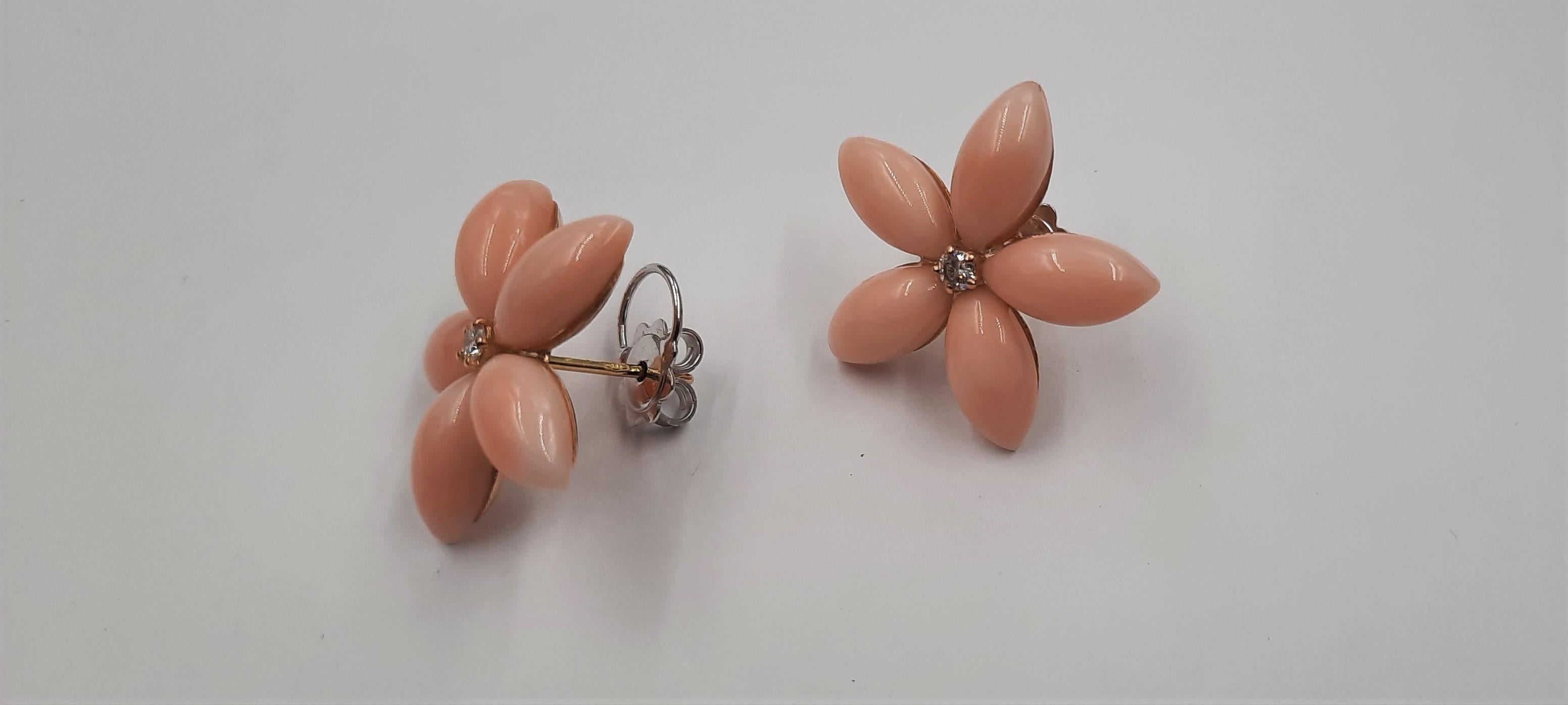 Pretty pink natural coral (3.9 grams), brilliant cut diamond (0.13 carats) and 18 carats  yellow gold (4.4 grams) flower earrings. They are replicable, even biggest and with coral of a different color (for example red). See Listings.The earrings are