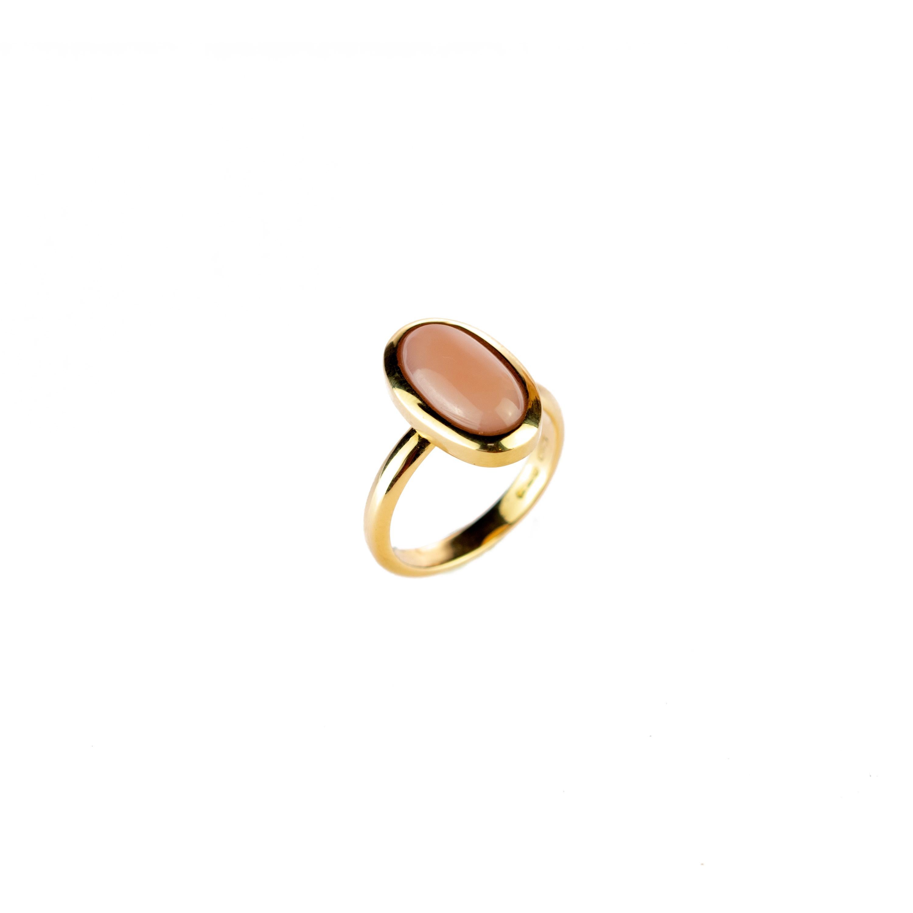  Delicate and stunning pink 5 carat natural coral ring. An oval cabochon surrounded by a 18 karat yellow gold circle. Crafted by our italian jewelers to magnify any feminine look. 
 
This ring is inspired by the Japanese cherry blossom, or sakura,