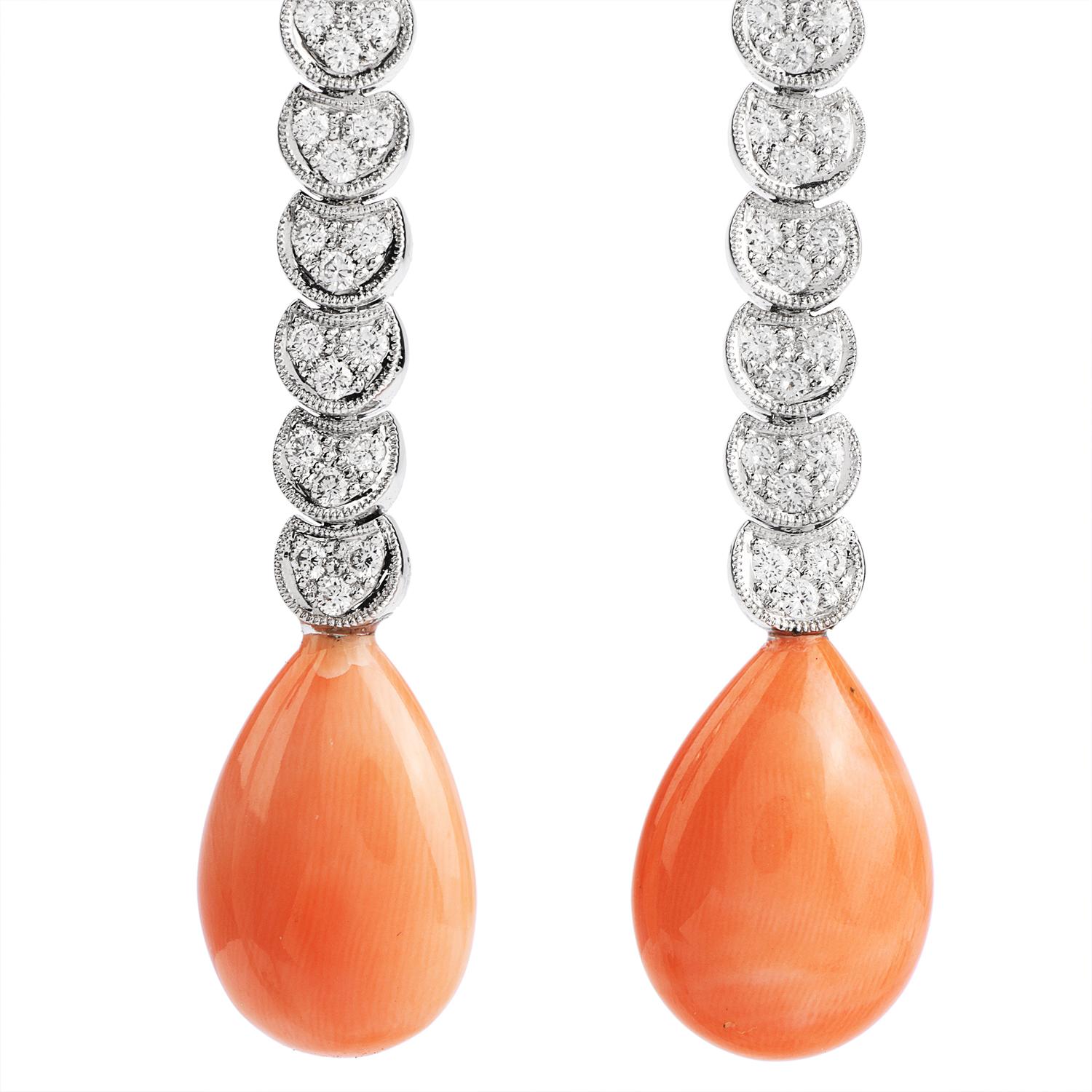  Soft Pink Colored Coral tear drops Clip On to the ear while 

large dangling diamonds dangle freely.

contrasting bright white round diamonds totaling approx. 0.56 carats.

Graded G-H color and VS2-SI1 clarity.

Secured with Clip On backs.

These