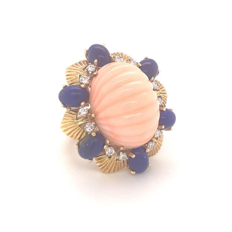 One step leveled, oval-shaped pink coral ring accented by oval-shaped, royal blue lapis lazuli beads and twelve round cut diamonds weighing 0.25 ct., G-H and VS-2. Eye-catching, chunky, bold.

Additional information:
Metal: 18K yellow gold
Gemstone: