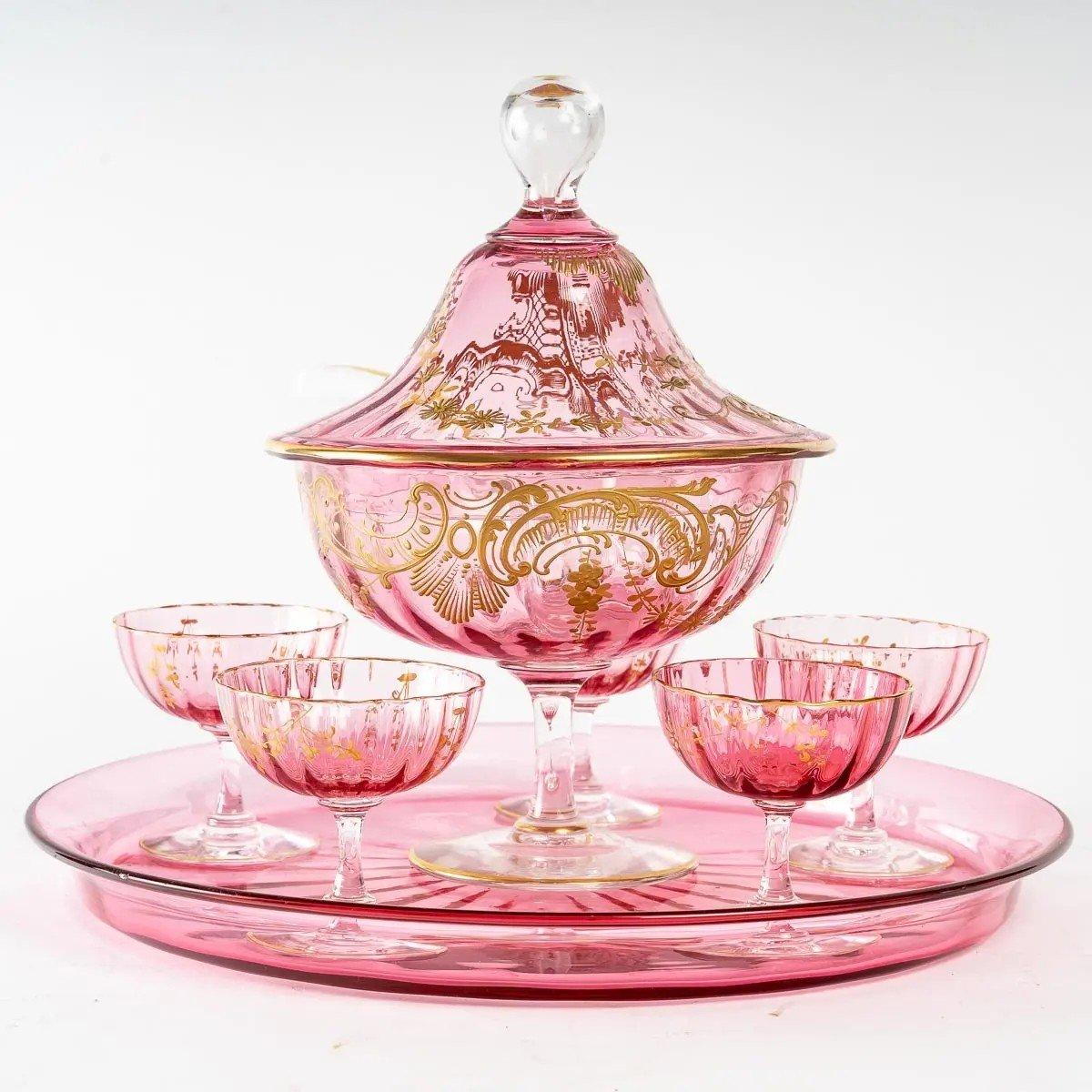 Pink crystal dinner service, 19th century
Splendid pink crystal dinner service, containing 5 glasses, a cup with its spoon and their tray. Napoleon III period, 19th century. 
Perfect condition. 
Tray - D: 29cm,
Glasses - H: 7 cm, W: 7 cm 
Cup -