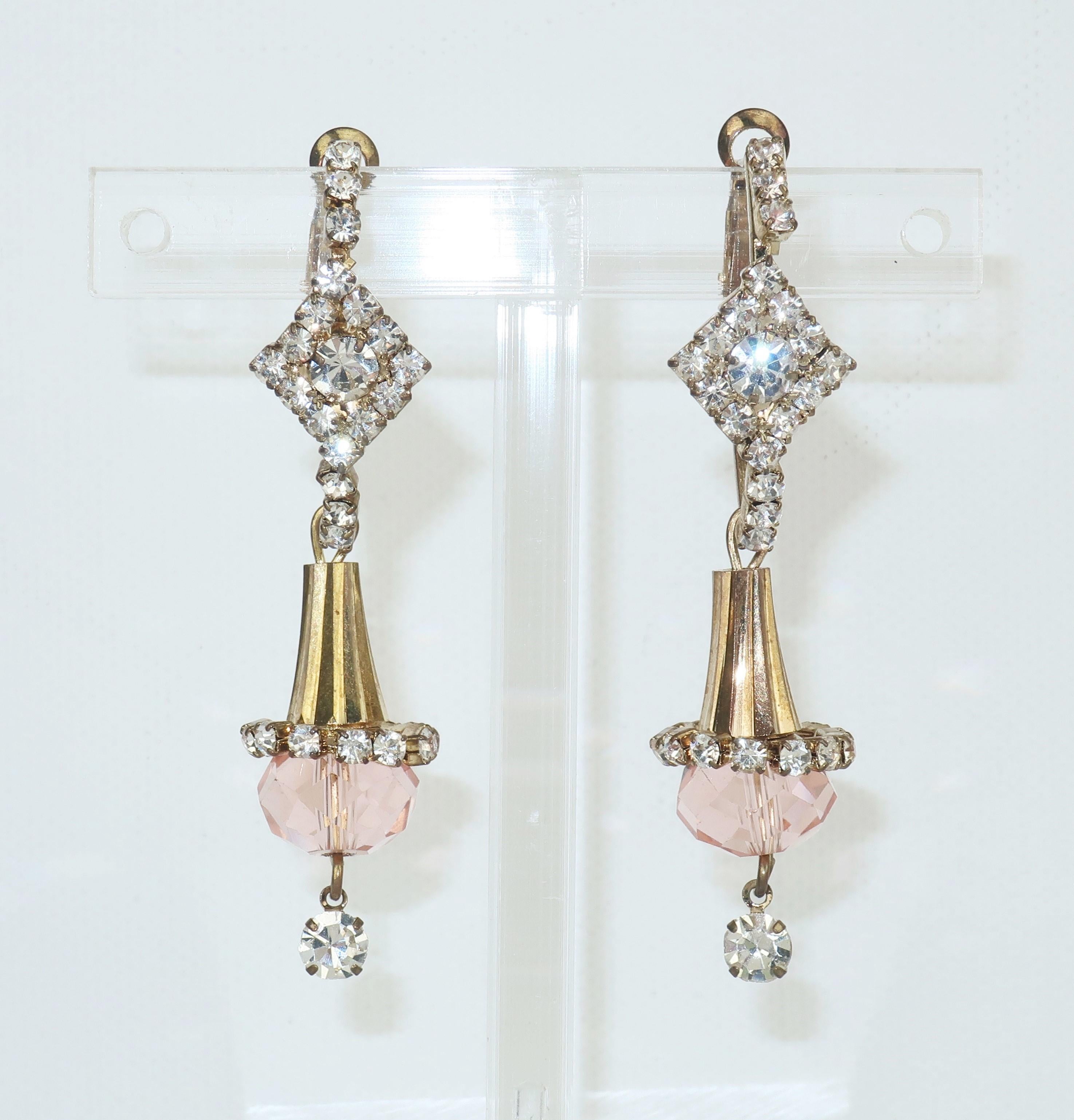 Pretty in pink!  Delicate and lovely 1960's earrings with a Belle Époque style in a gold tone metal with rhinestone embellishments and a pale pink faceted crystal drop.  The pierced post hardware features a lever back for easy wear.  No maker's