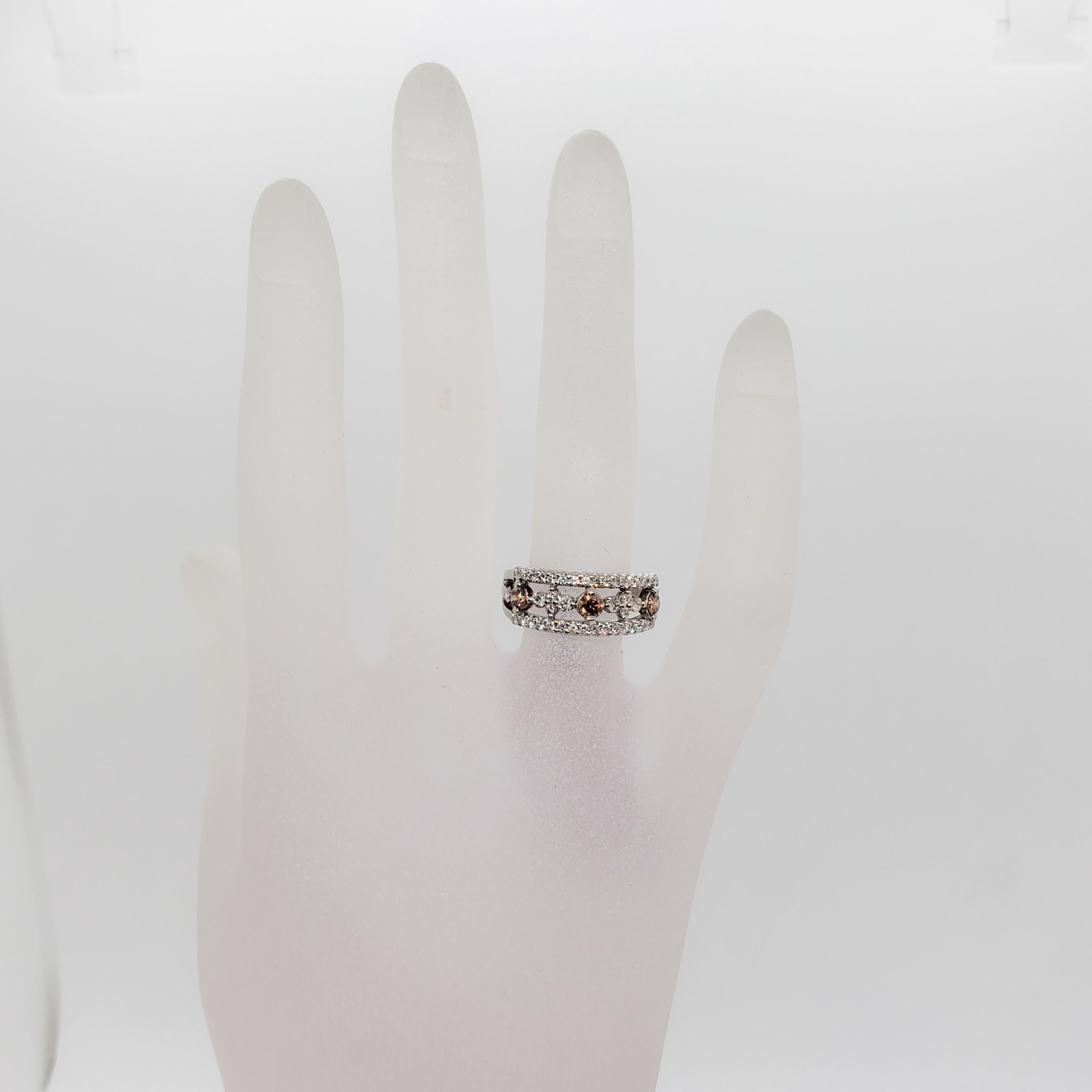 Gorgeous 0.32 ct. pink diamond rounds (3 stones) with 0.48 ct. of white diamond rounds.  Handmade platinum mounting in size 6.25.  The pink diamonds have a great color and the design of this piece makes it wearable everyday or for a special occasion.