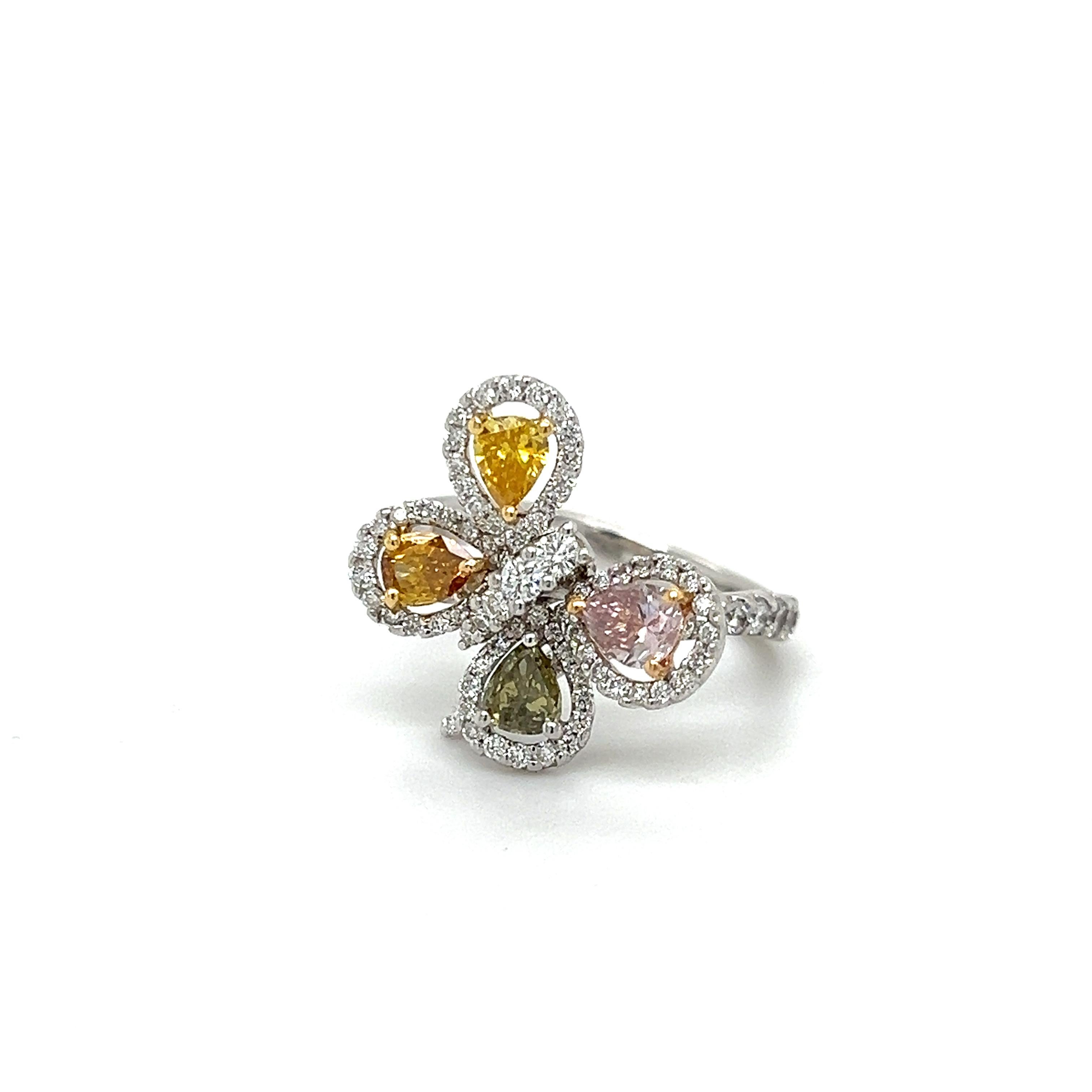 Beautiful design crafted in 18k white gold. The ring highlights natural fancy colored diamonds in a butterfly design. The ring is set with four naturally colored fancy diamonds. Pink, Orange, Yellow & Brown.  
The pear shaped diamonds act as the