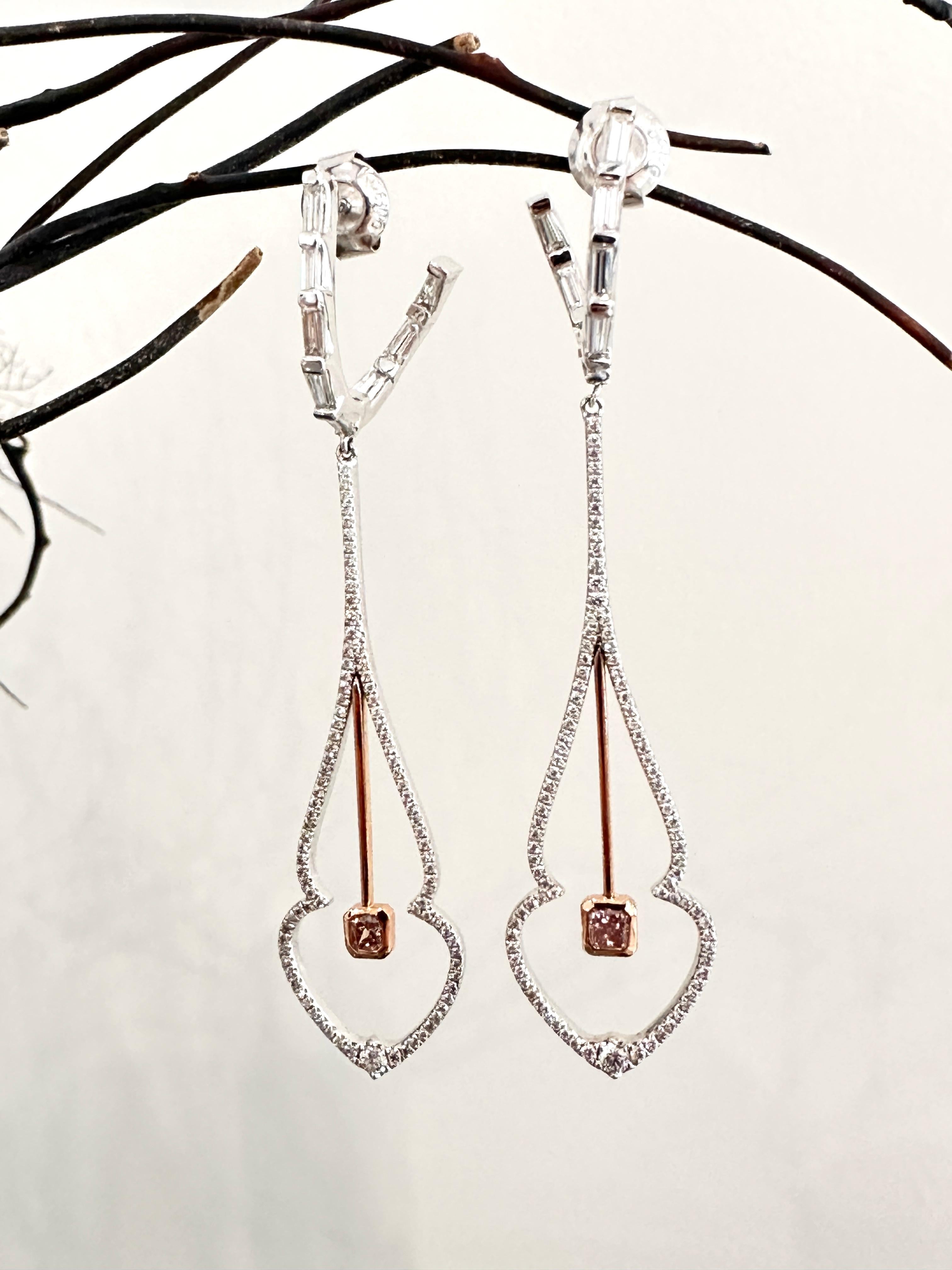 Pink diamond drop earrings designed in 18k white and rose gold. Including 2.2ctw diamonds and 0.14ct natural pink diamonds. 

These elongated elegant drop earrings are a bejeweled in baguette and pave diamonds. A firefly's wings are perfectly shaped