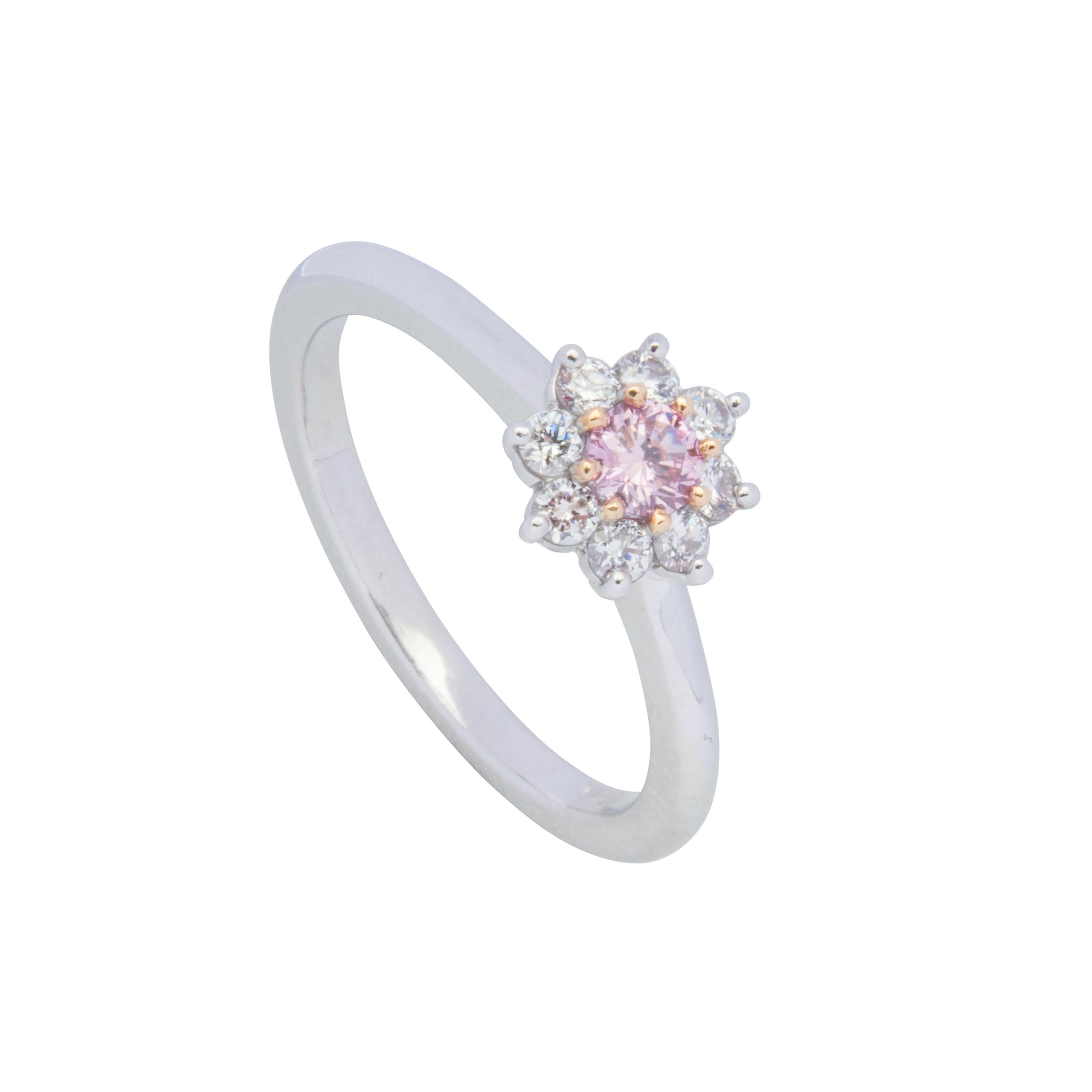 18 karat white and rose gold flower ring featuring 1 certified Argyle Pink Diamond 0.13ct 5PP/SI, also set with 8 round brilliant cut diamonds.  Size US5.5, sizeable +2 or -2.