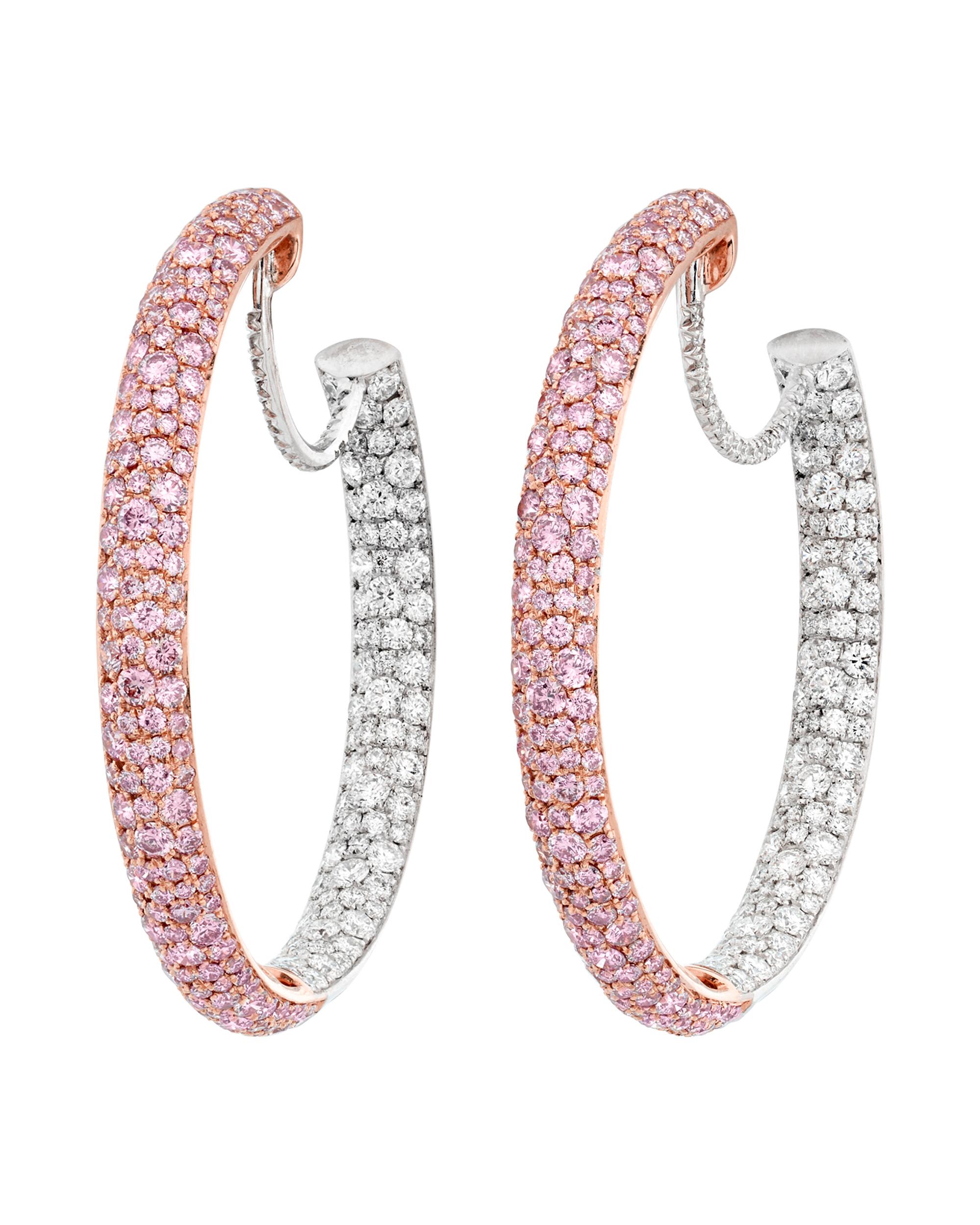 This classic pair of hoop earrings boasts a modern elegance and two-tone design. A brilliant array of 280 pink diamonds totaling approximately 2.91 carats is embedded at the front of the stunning pair. The reverse features white diamonds totaling