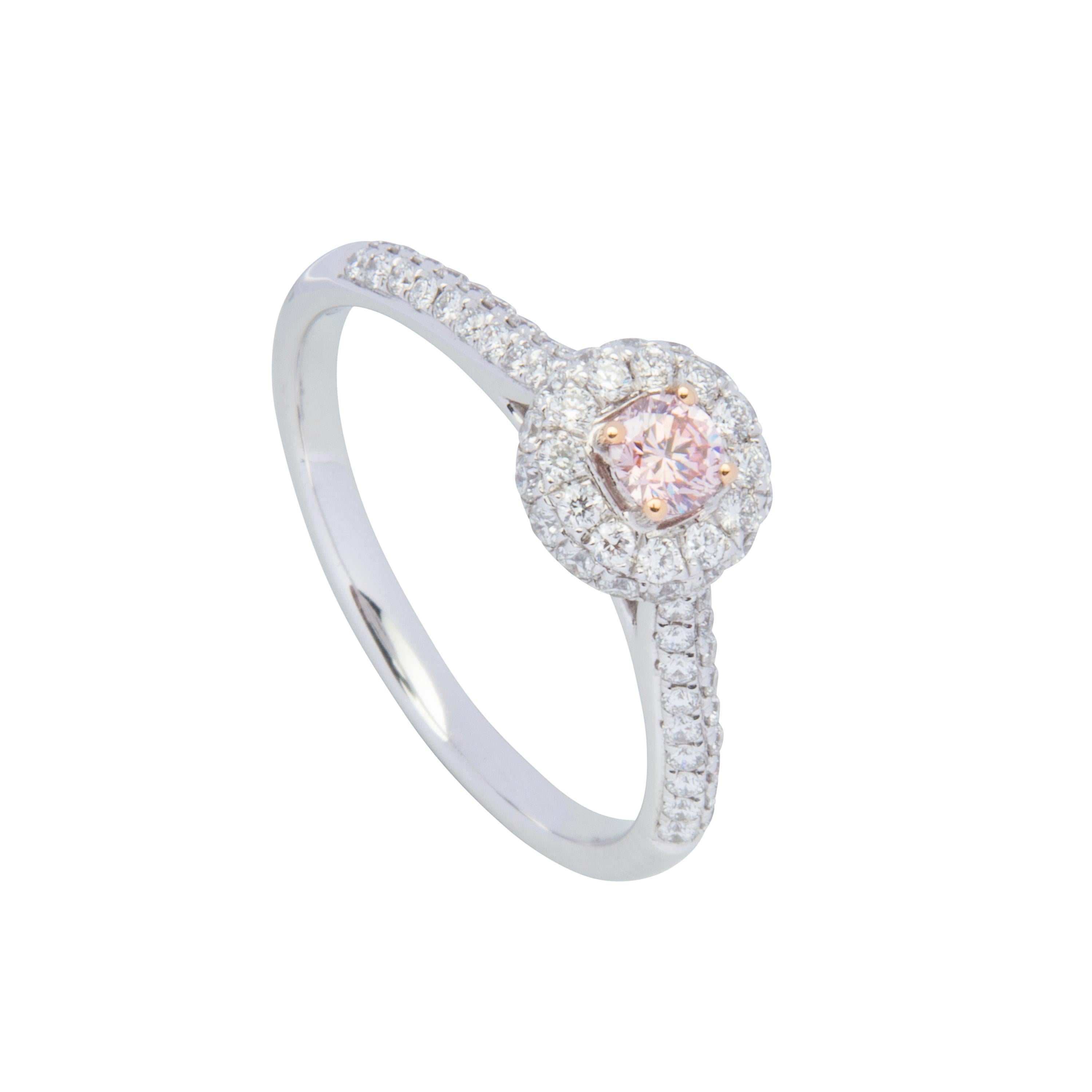 18 karat white and rose gold ring featuring 1 certified Argyle Pink Diamond 0.15ct PC1/VS1, also set with 72 round brilliant cut diamonds totalling 0.47ct.  Size US6.5, sizeable +2 or -2.