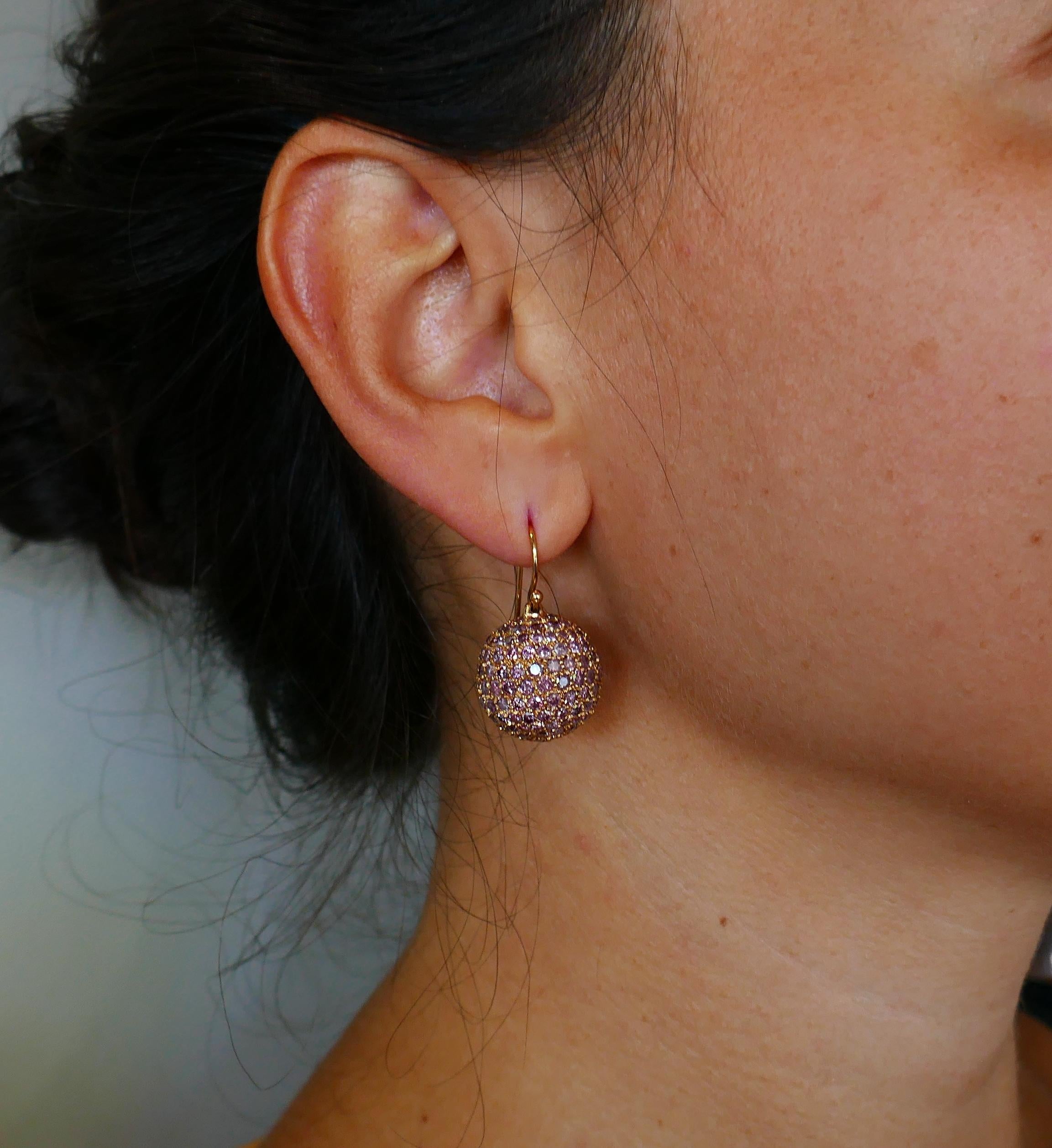 A pair of trendy and wearable earrings. 
Made of 18 karat rose gold and pave-set with round brilliant cut pink diamonds (total weight approximately 11.0 carats). 
Measurements: Diameter slightly under 3/4 inch (1.7 cm).   Height 1-1/8 inch (3