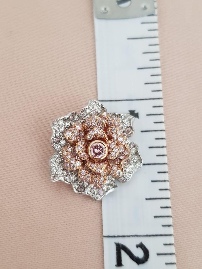 Beautiful Rose Pendant in 18K White and Rose Gold meticulously handcrafted with 95 pink melee diamonds = 0.49 carat plus 1 center pink diamond of 0.10 carat. 100 white melee diamonds = 0.45 carats. Chain not included but is available for purchase